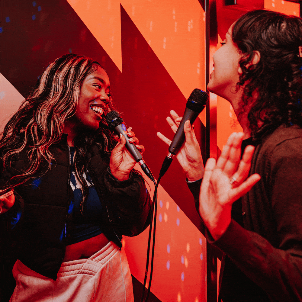 Group shots of children and adults enjoying karaoke at PLAYBOX in Croydon