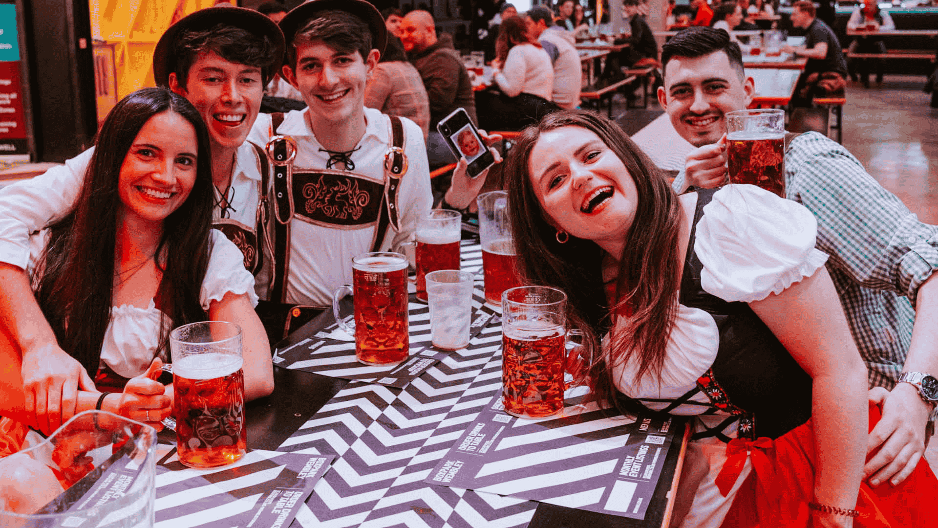 Guests drinking steins during Oktoberfest at Boxpark