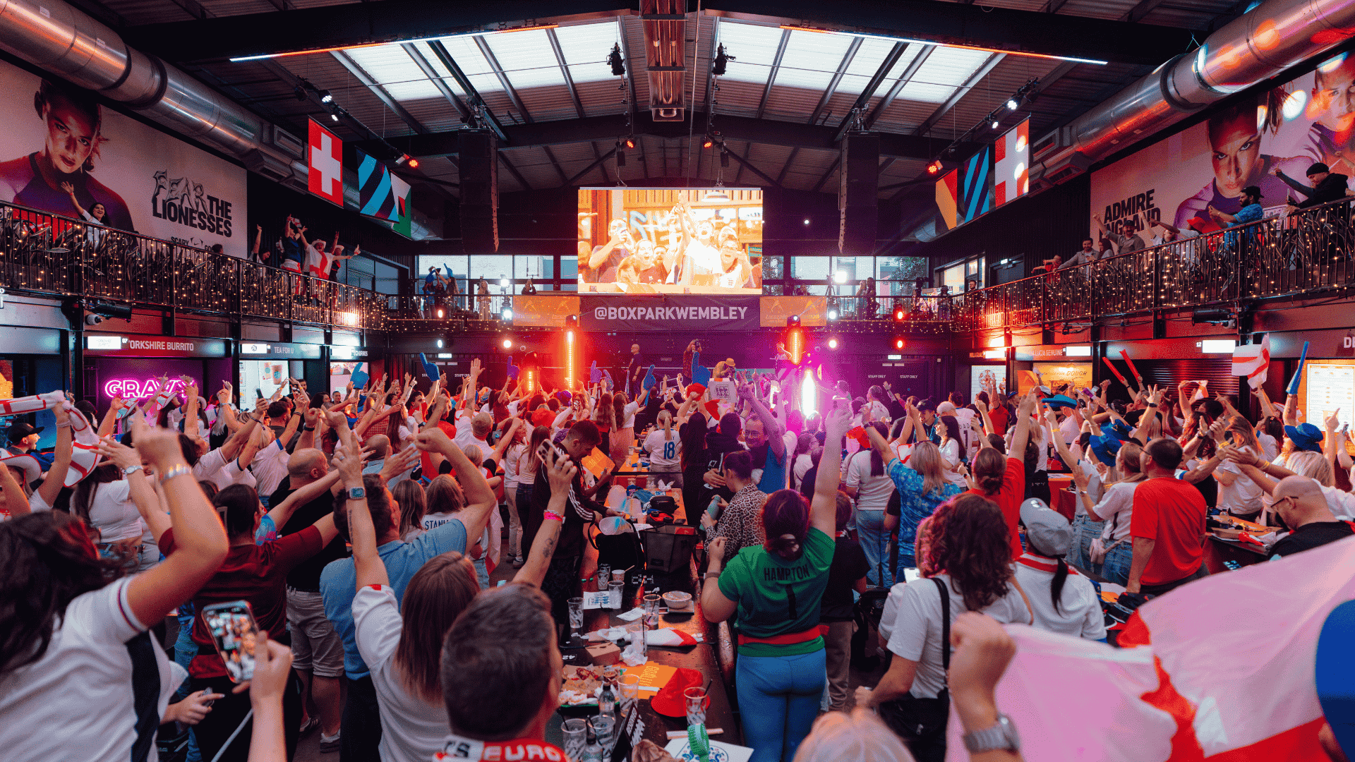Guests watching football at BOXPARK