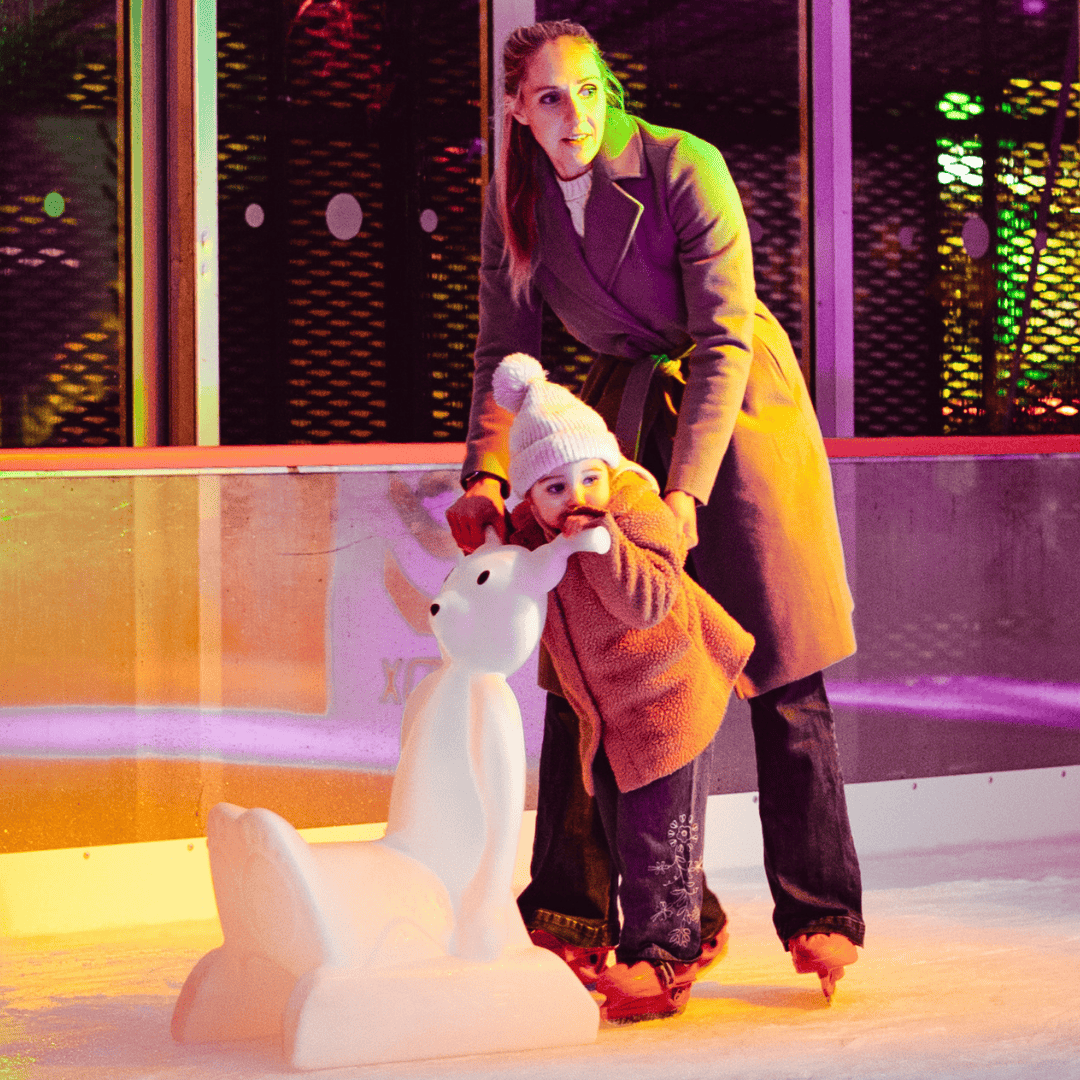A parent and child ice skating at boxpark liverpool