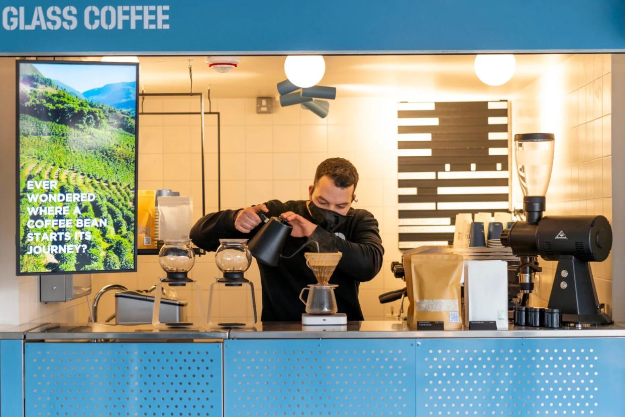 A barista making a coffee at Glass Coffee in Camden
