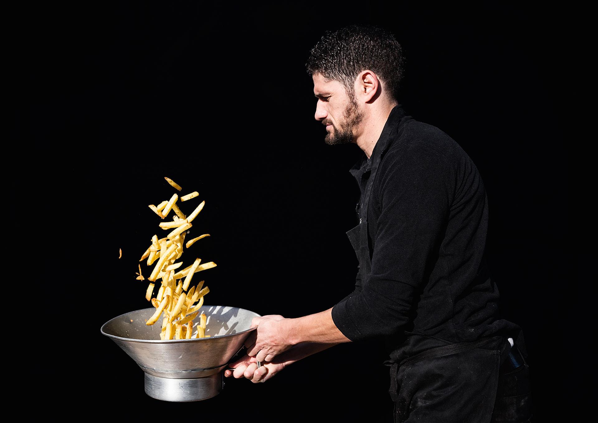 A chef tossing fries at Poptata in Boxpark Camden