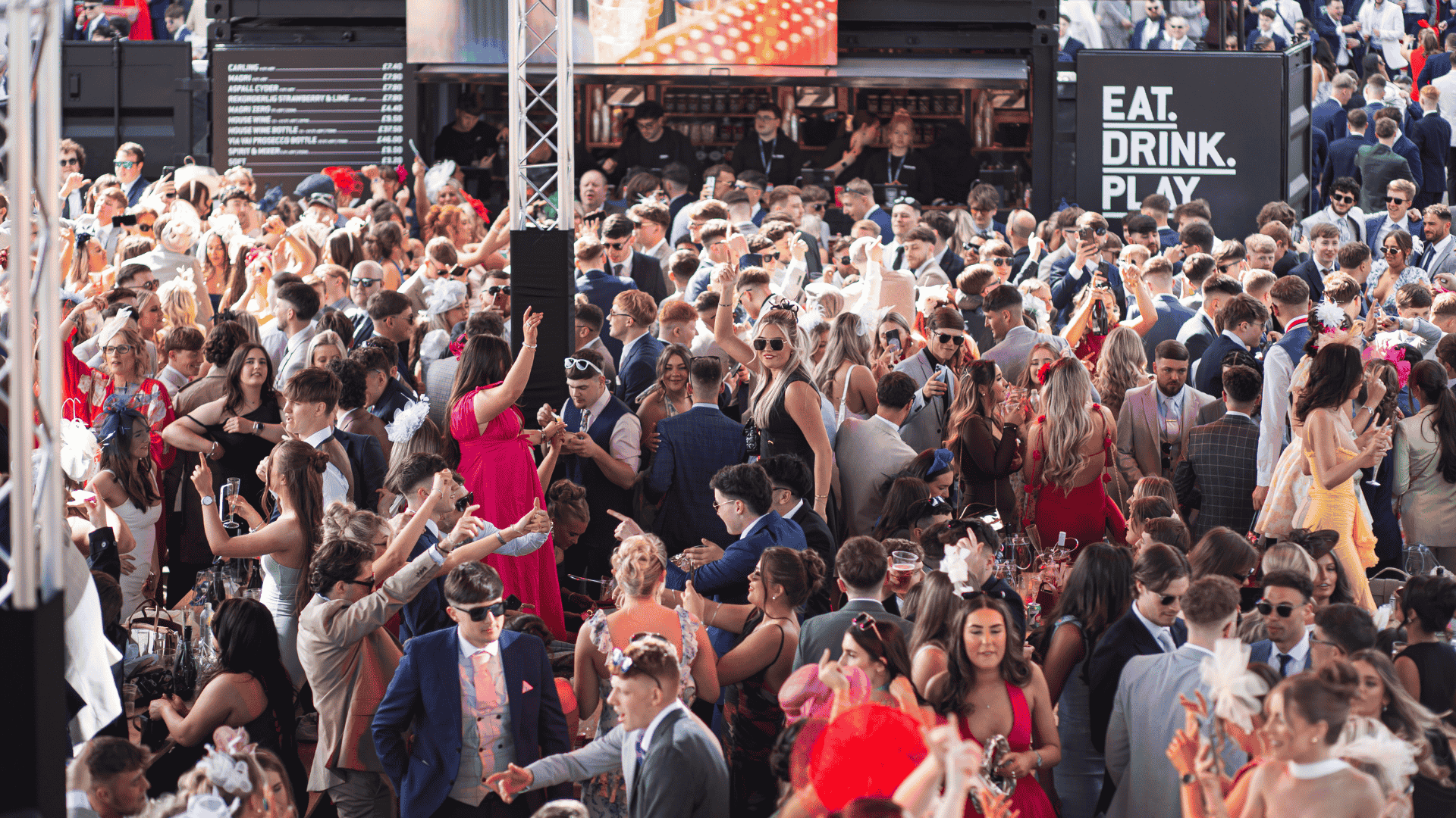 Guests drinking and dancing at BOXPARK's pop up at Aintree