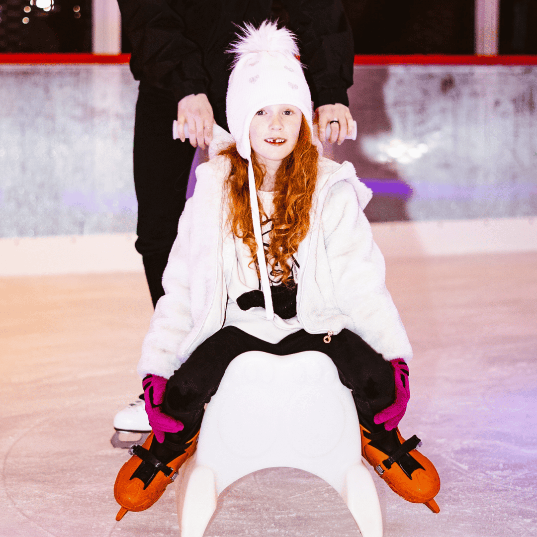A girl using a Skate Aid while Ice Skating at BOXPARK in Liverpool