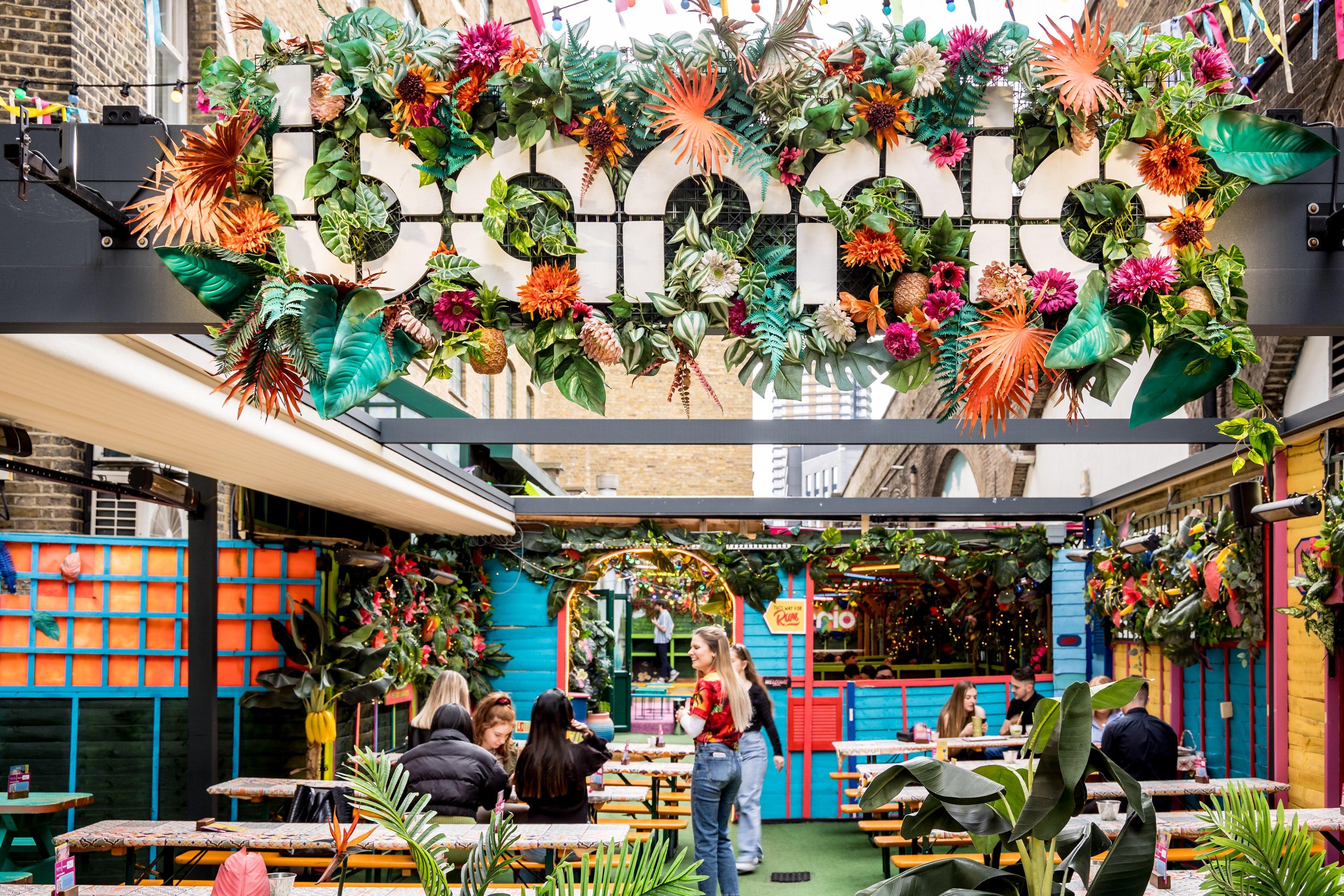 People sitting in the garden area outside of Barrio in Shoreditch