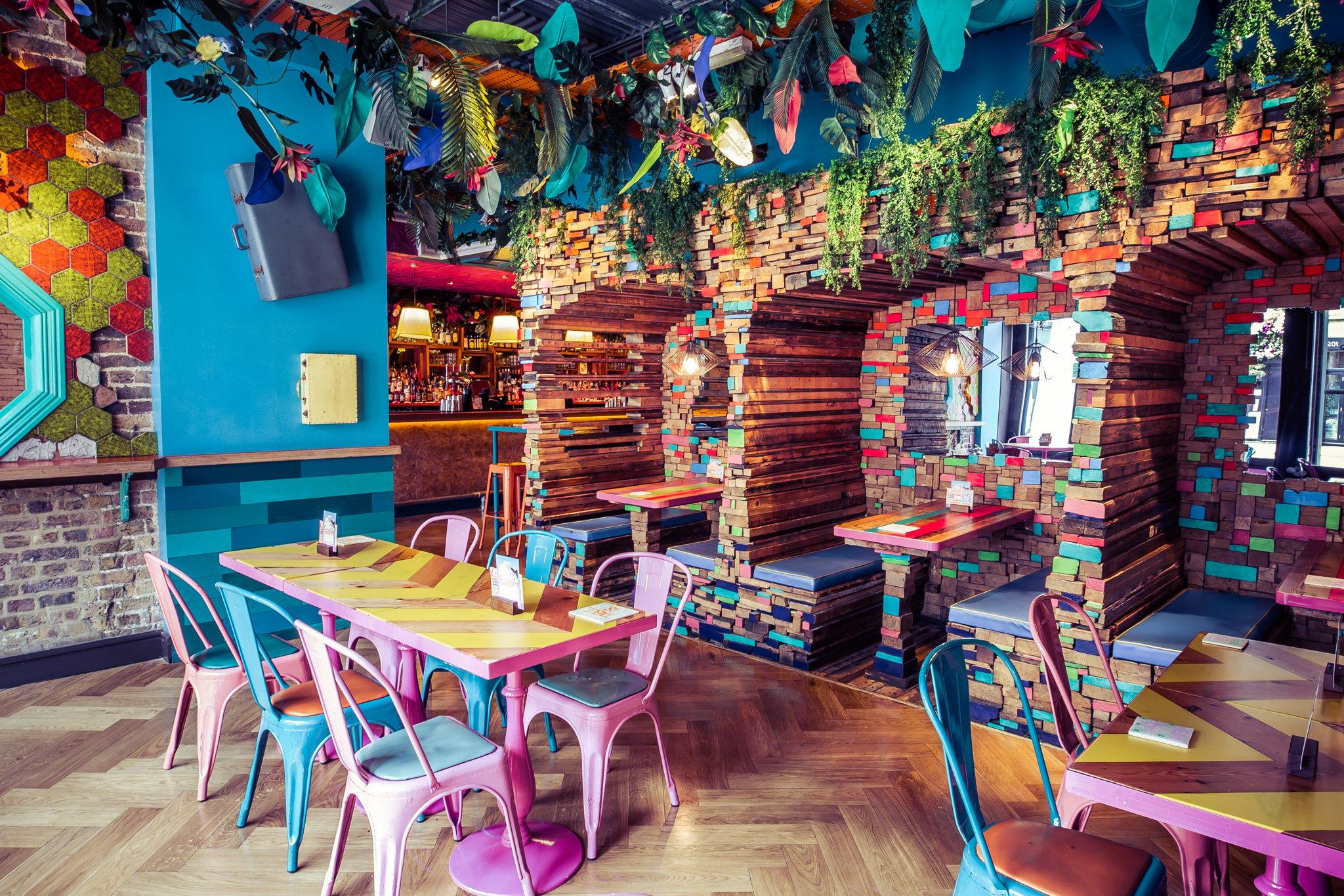 A quirky and colourful private space in a bar with booths made of timber