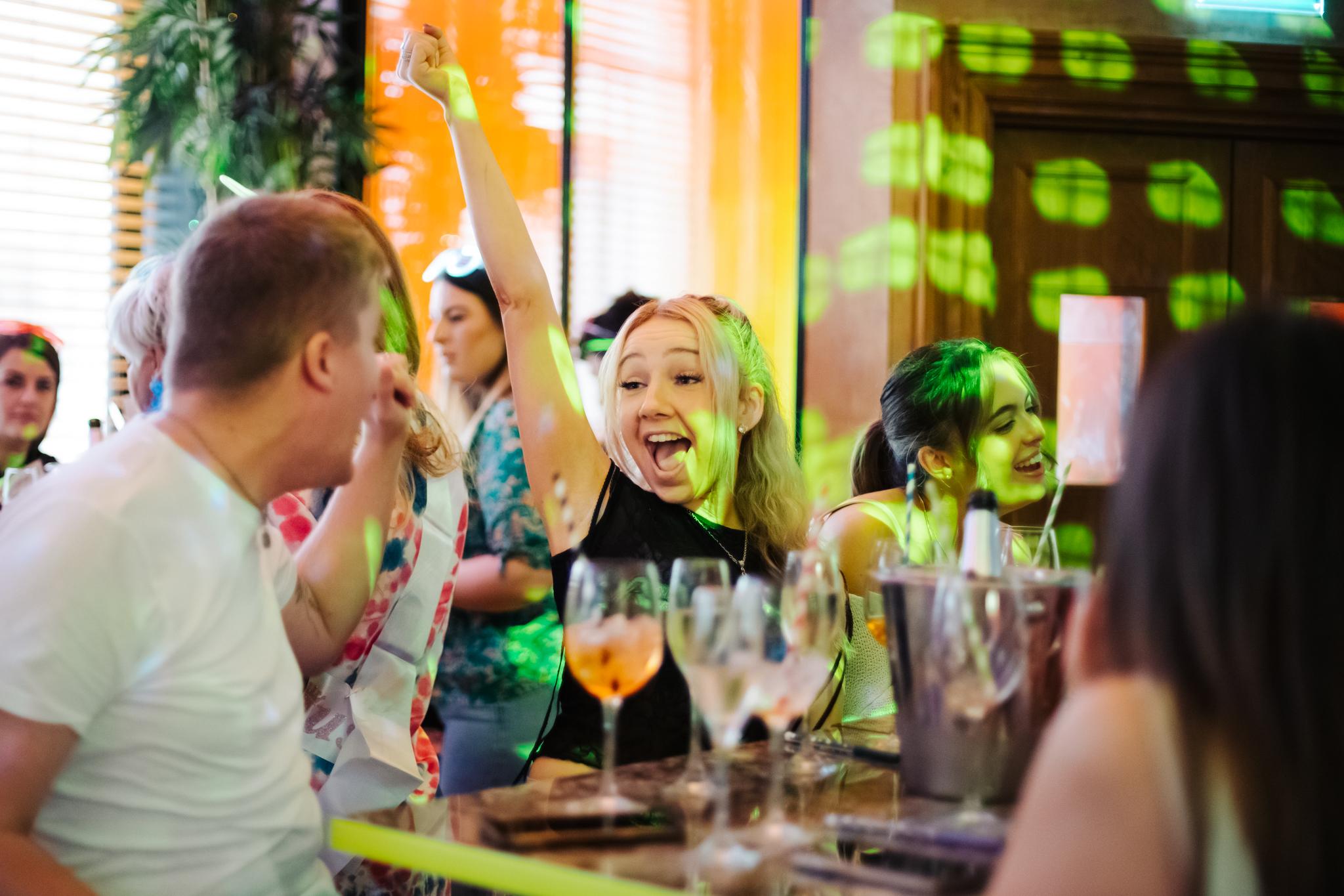 Female customer enjoying a bottomless brunch in Nikki's bar