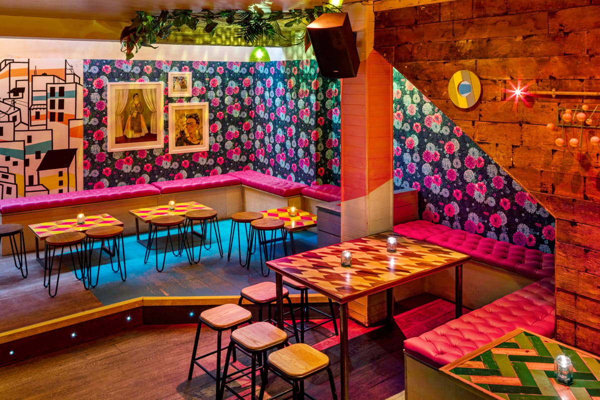 Bold and bright interiors of the downstairs area of Barrio in Soho. 