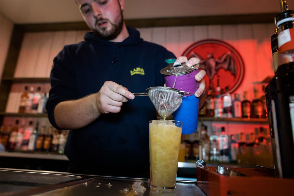 Barman pouring a cocktail into a glass at Luna Springs in Digbeth, Birmingham.