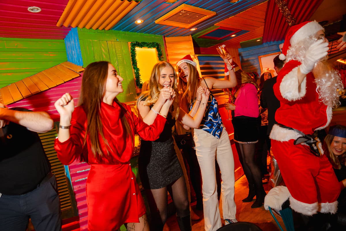 Women dancing at a Christmas bottomless brunch event in Barrio