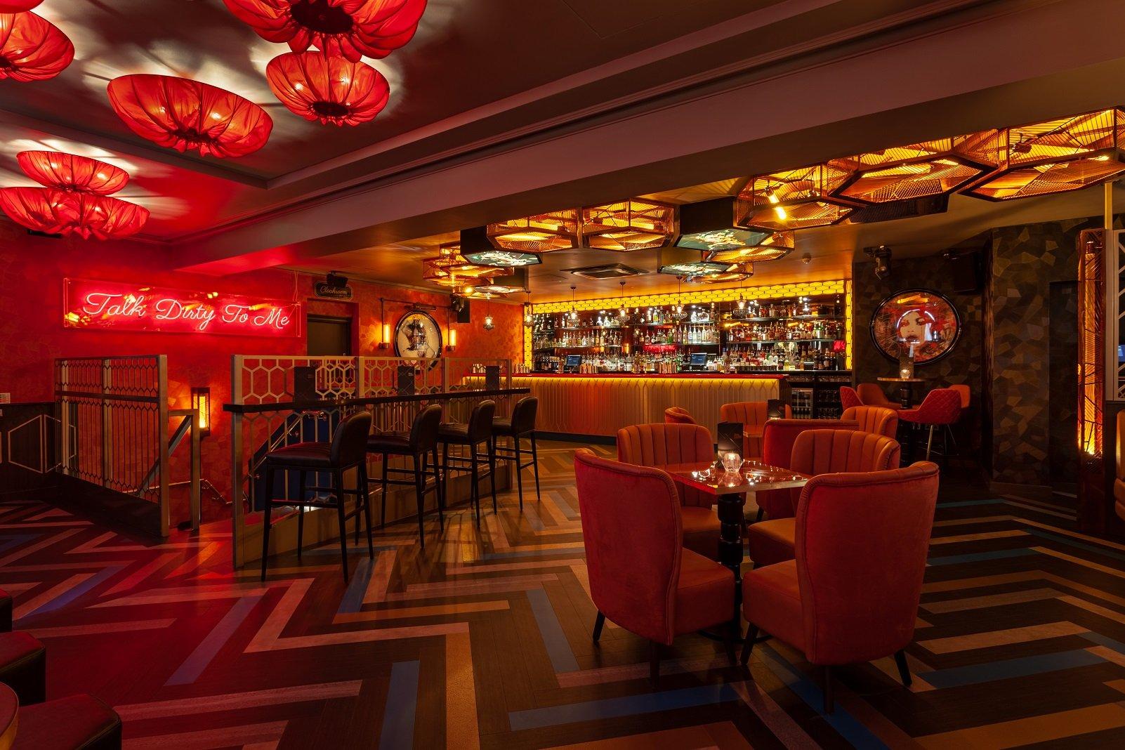 A private hire space with private bar, seating and neon sign