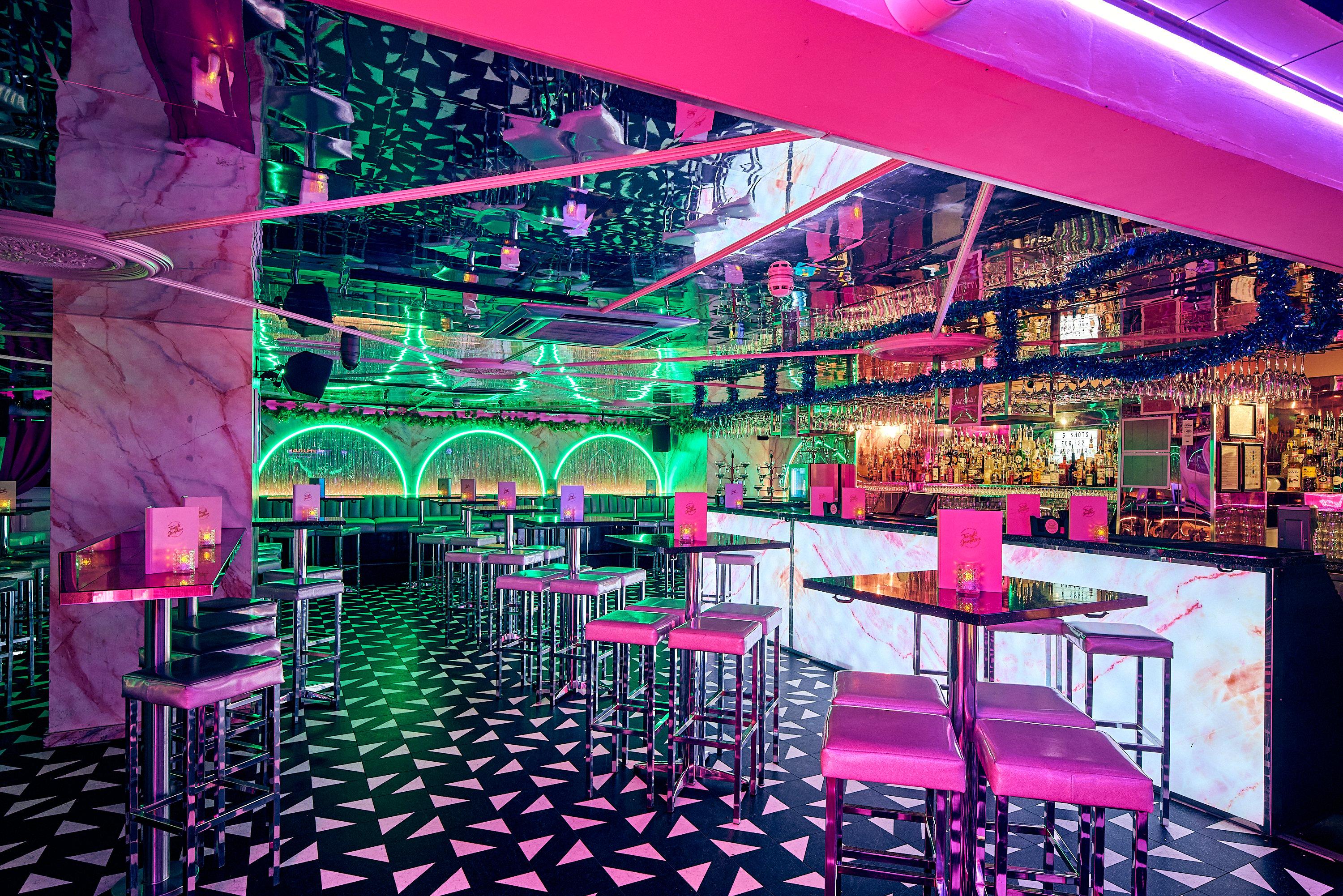 The main bar area showing a patterned floor and mirrored ceilings