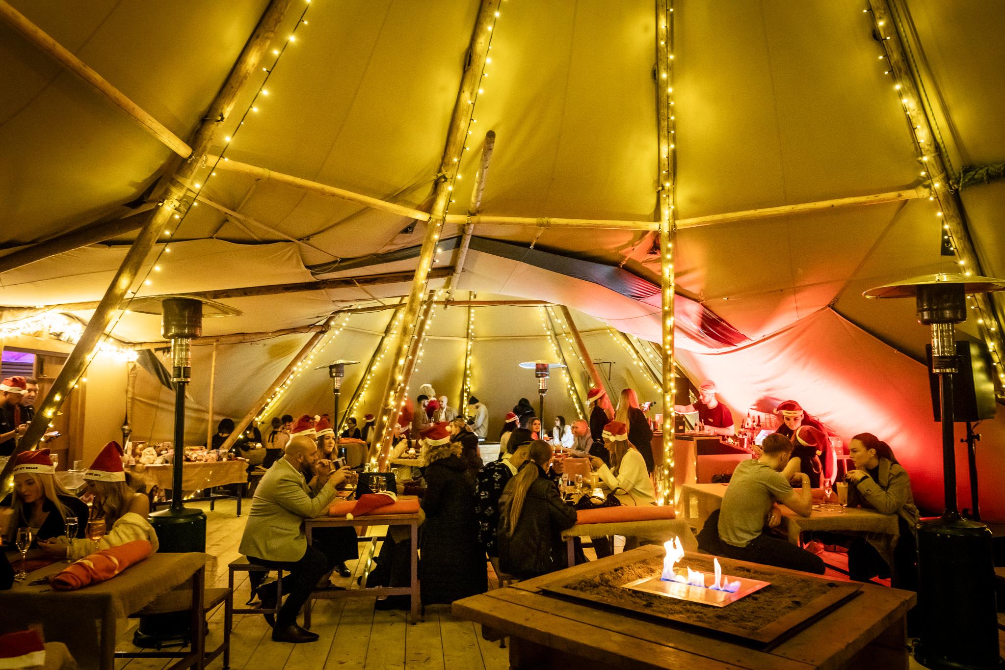 Guests in a festive teepee tent in Luna Springs 