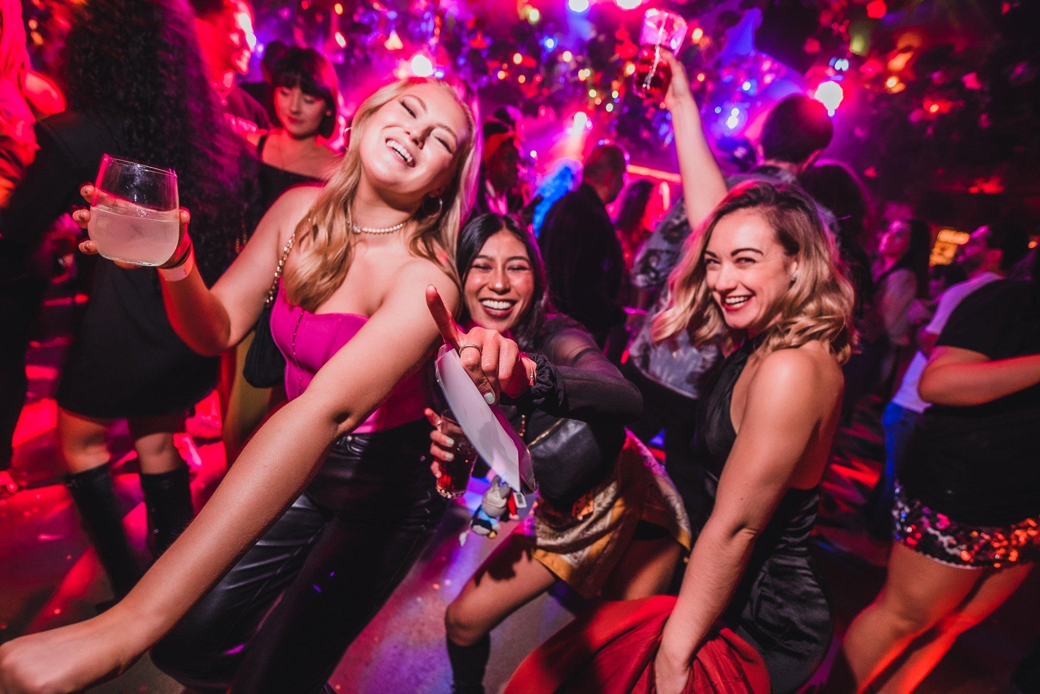 Women dancing and drinking in Barrio