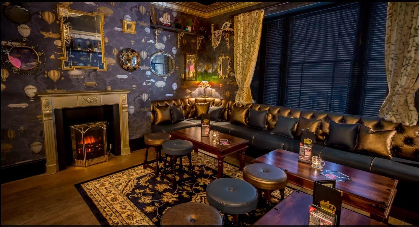 Private hire room with patterned wallpaper and cosy seating