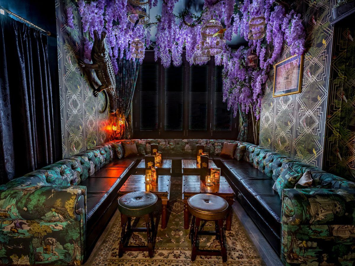 A cosy seating area with low tables and a floral ceiling. 