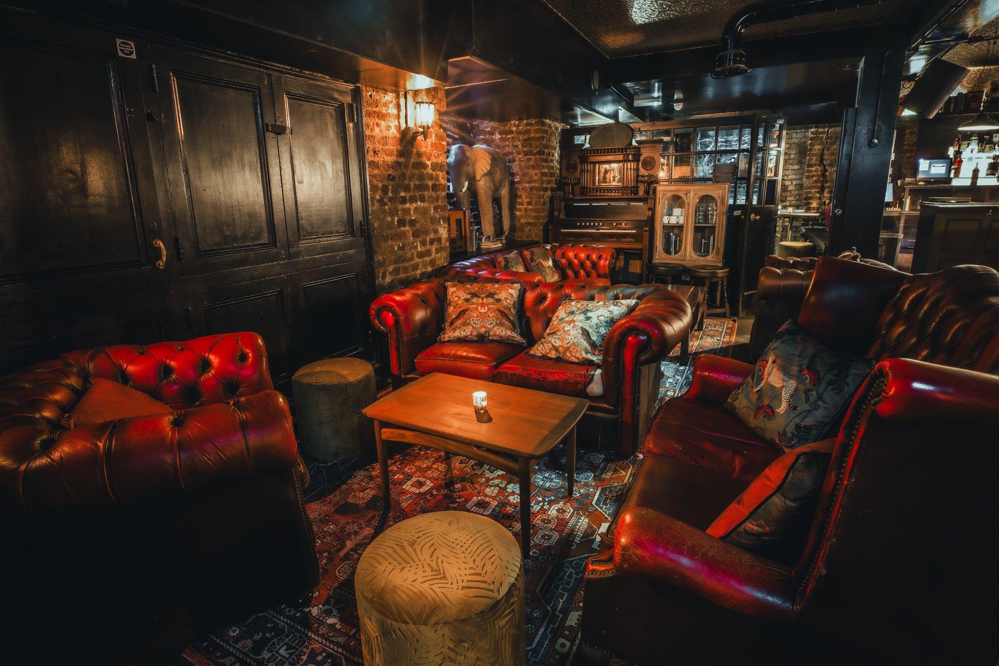 A private area of a bar with leather sofa seating