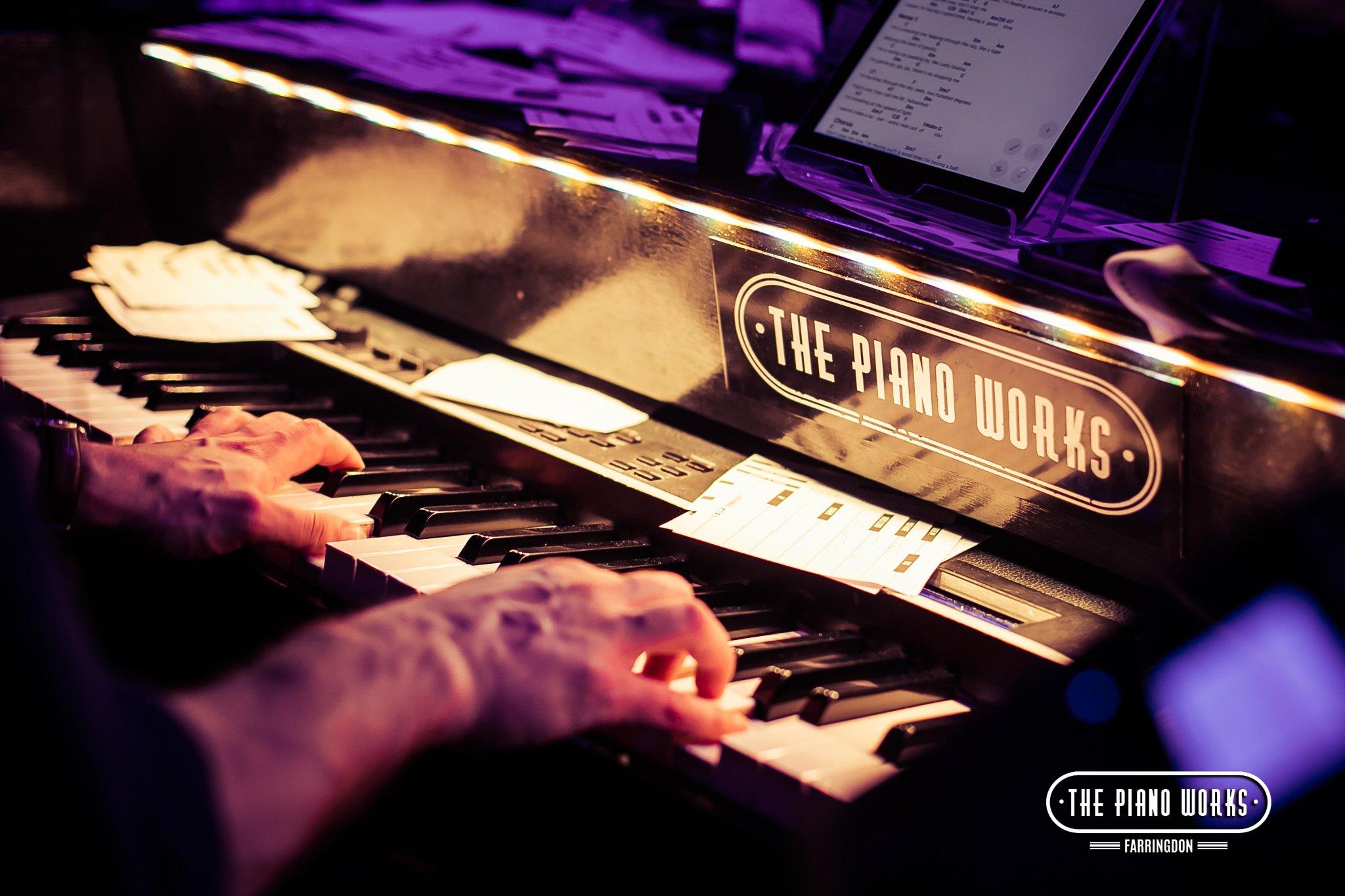 Close up of a musicians hands playing the Piano in The Piano Works