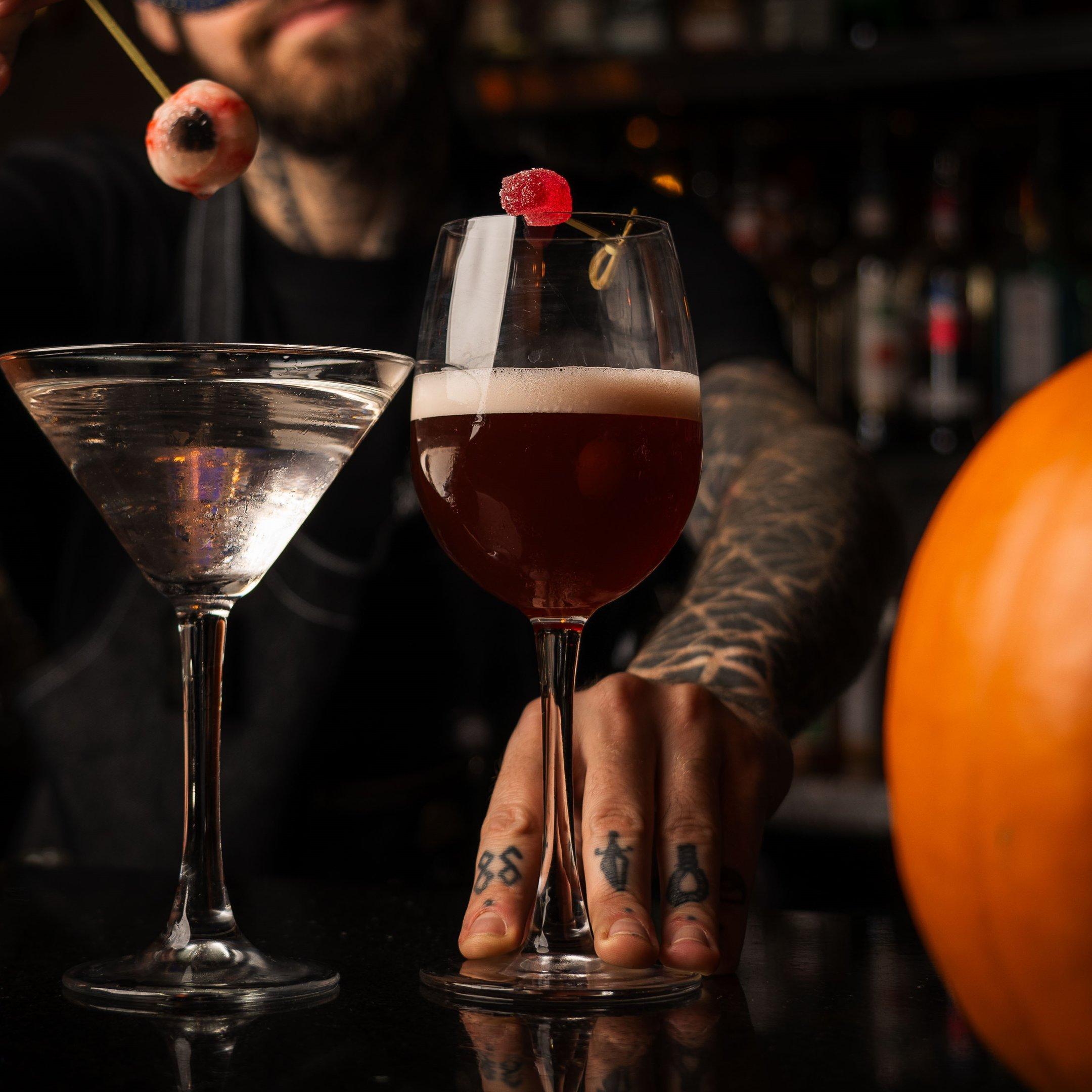 Image of a red Halloween cocktail with a sweet garnish