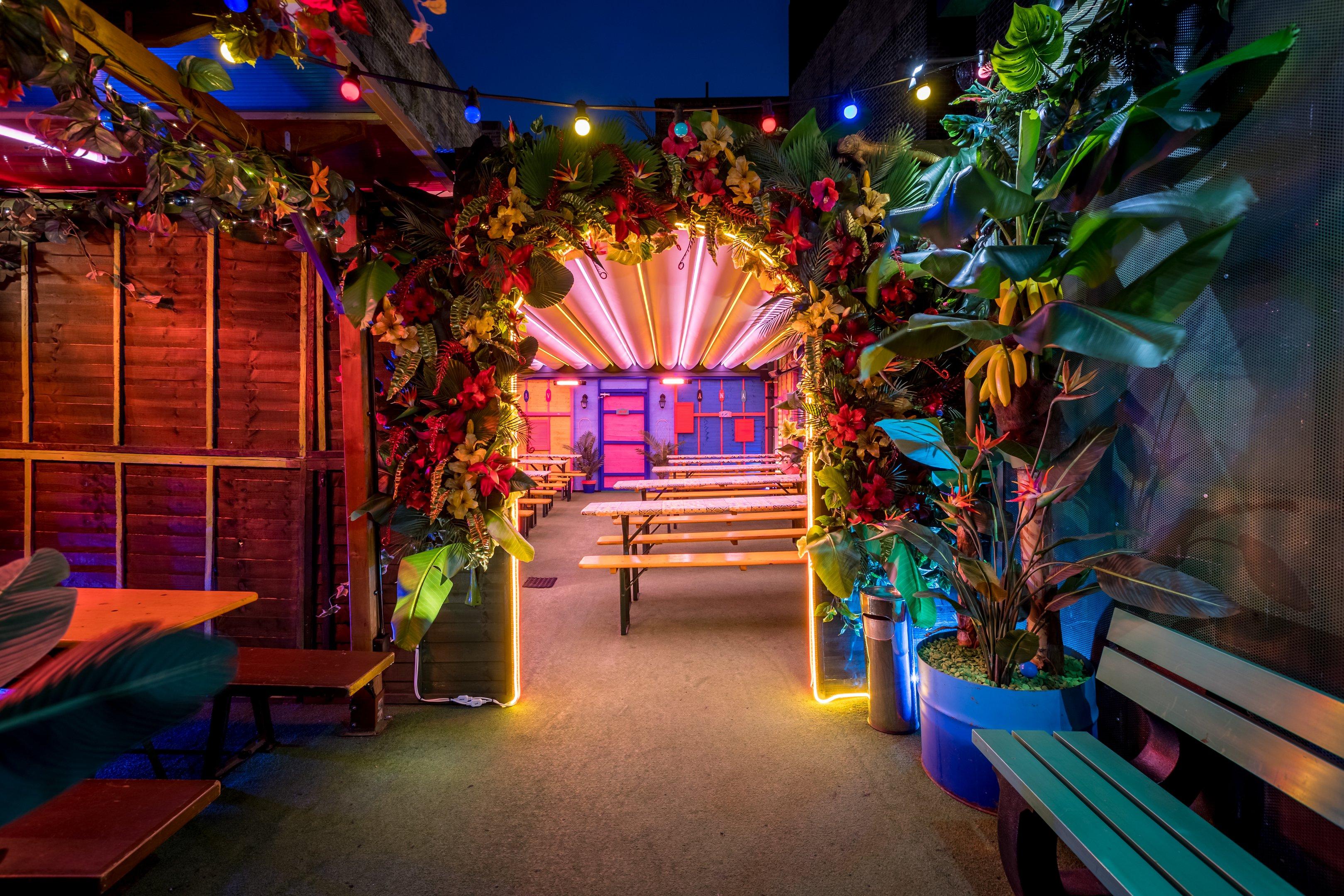 A floral archway leading to the Winter Lodge in Barrio Shoreditch