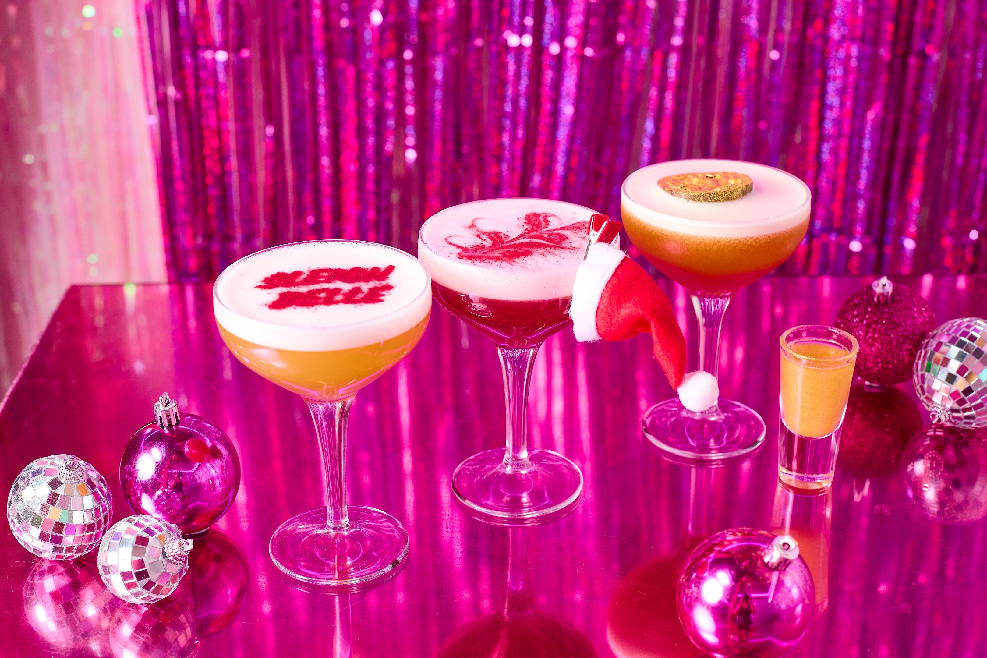 Three Christmas cocktails on a pink table at Tonight Josephine