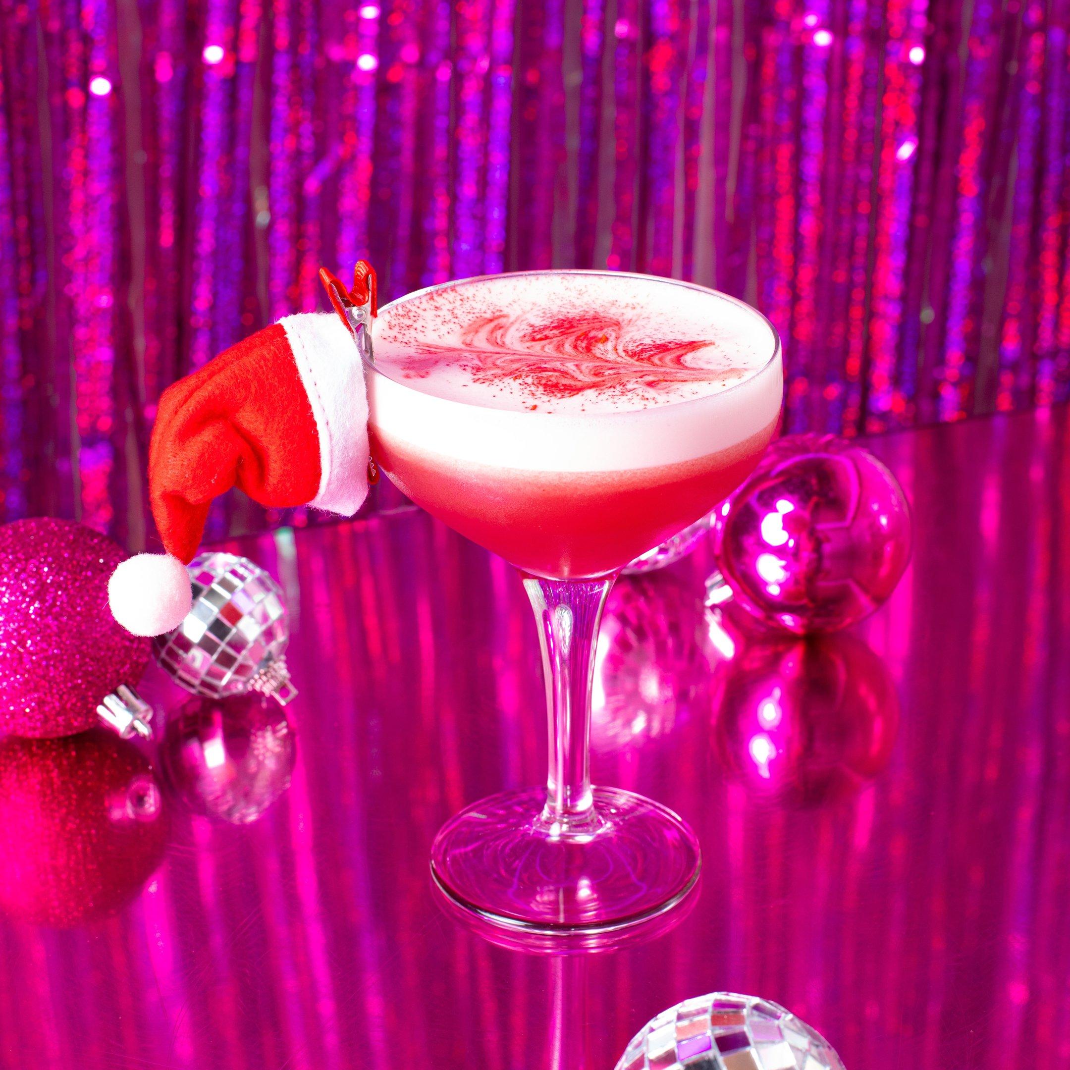 Christmas cocktail with a Santa Hat clipped to the side of the glass