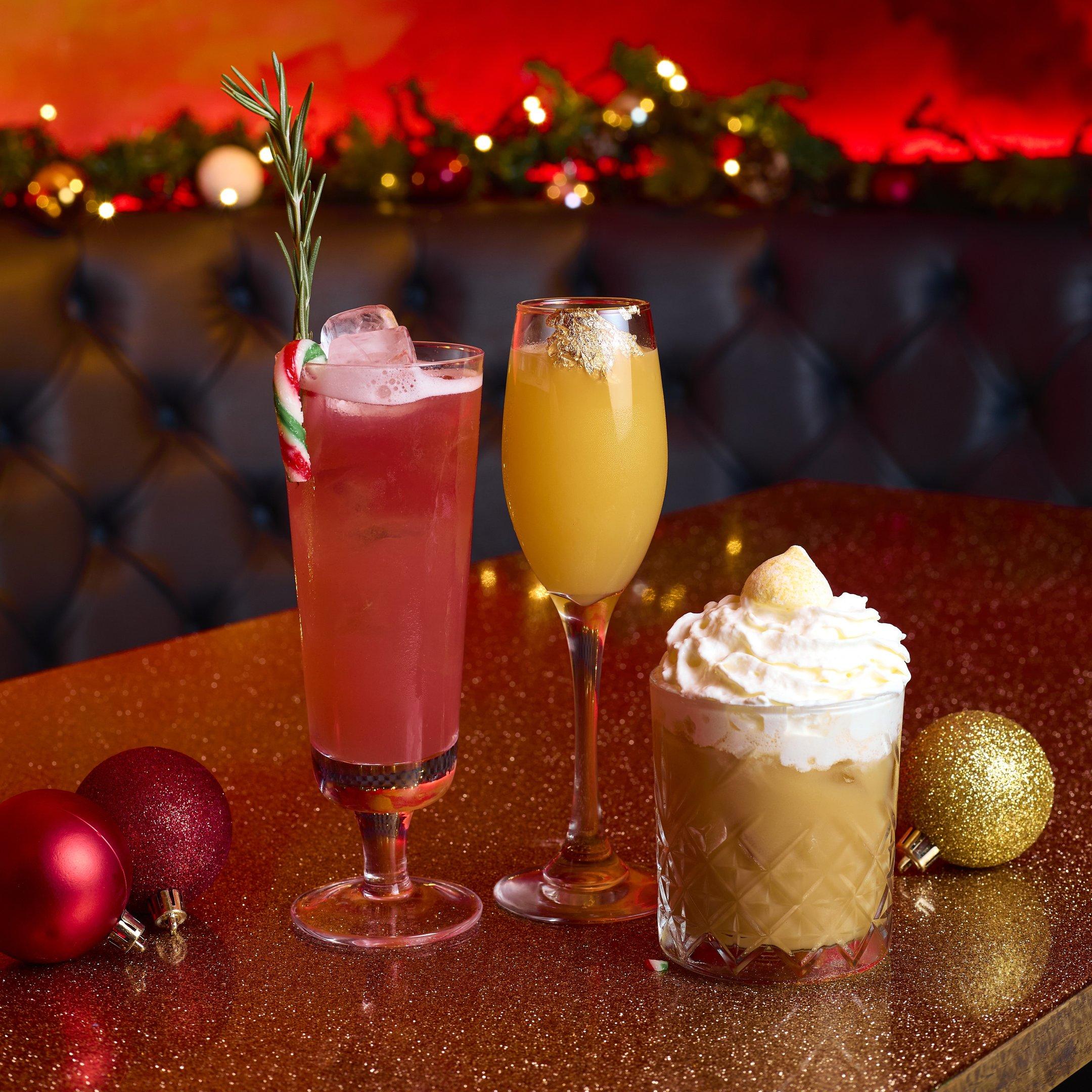 Three Christmas cocktails on a glitter table at The Escpologist