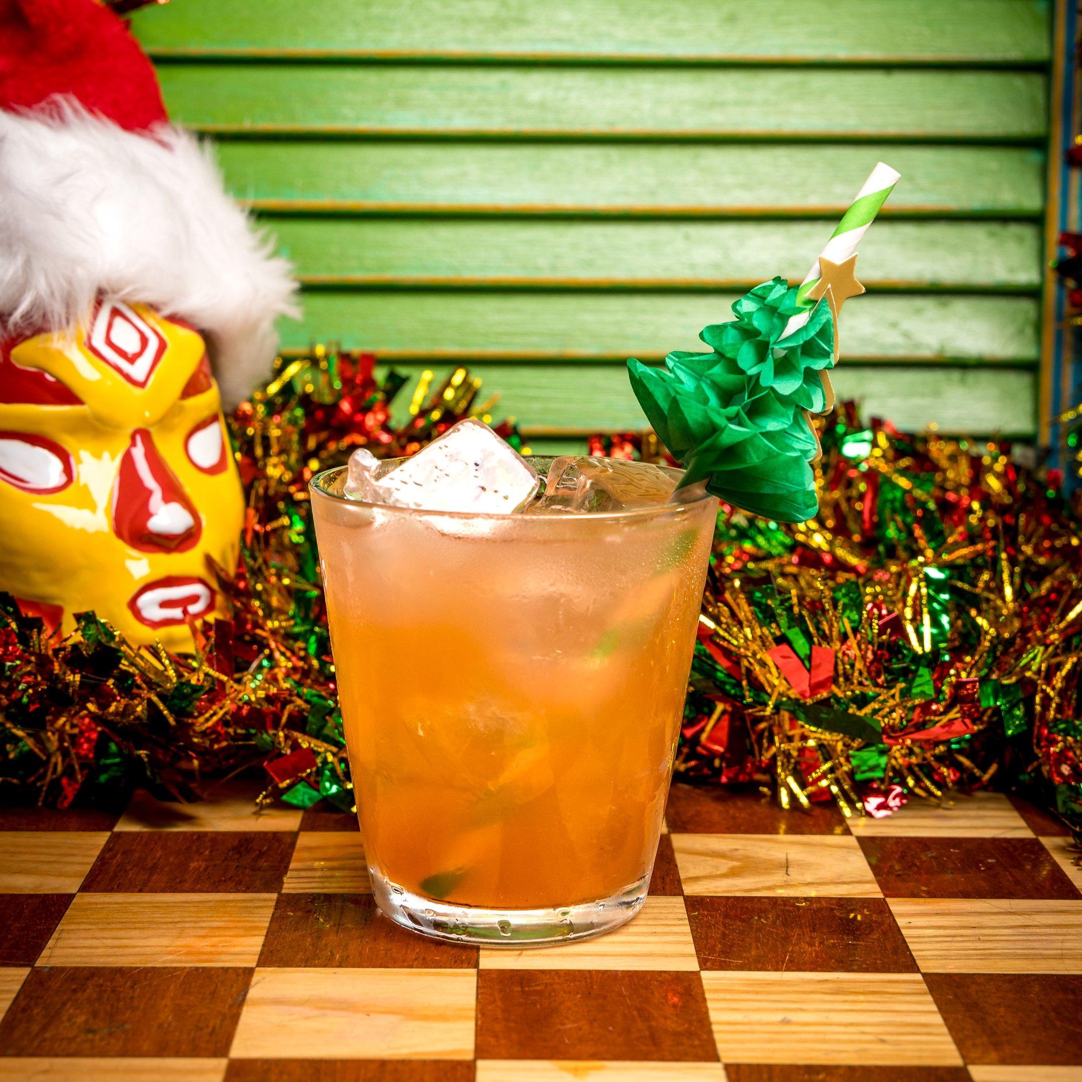 A Christmas cocktail with a Christmas tree garnish