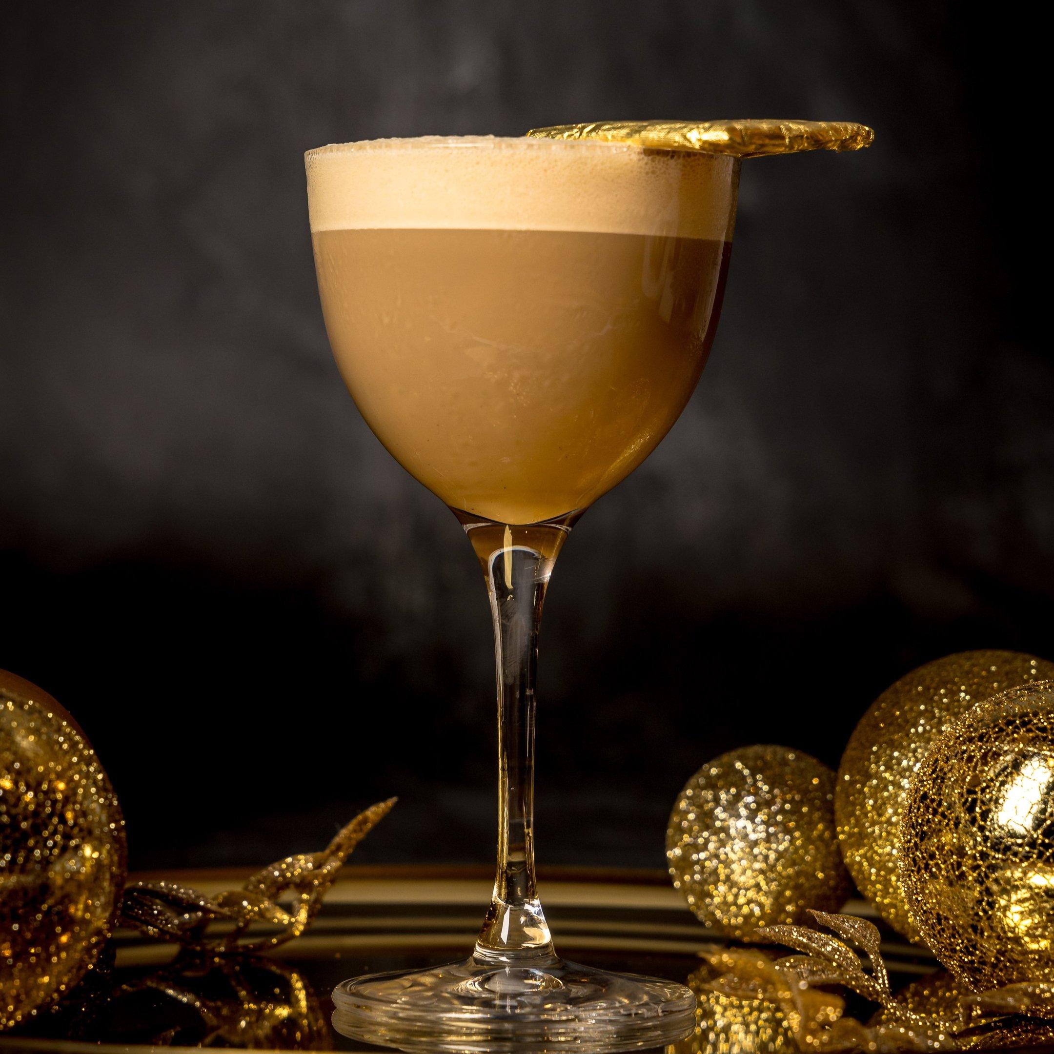 Christmas cocktail with a gold garnish