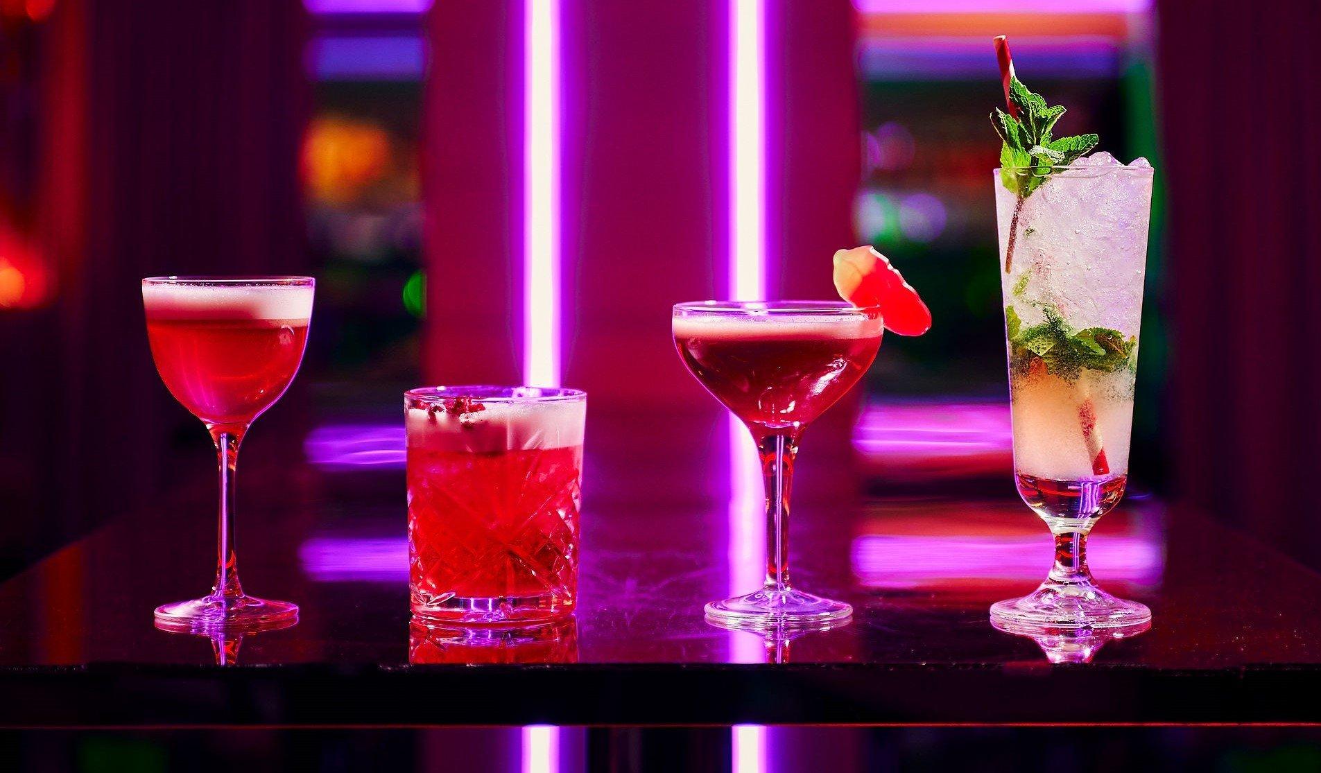 Four cocktails lined up on a table in Tonight Josephine