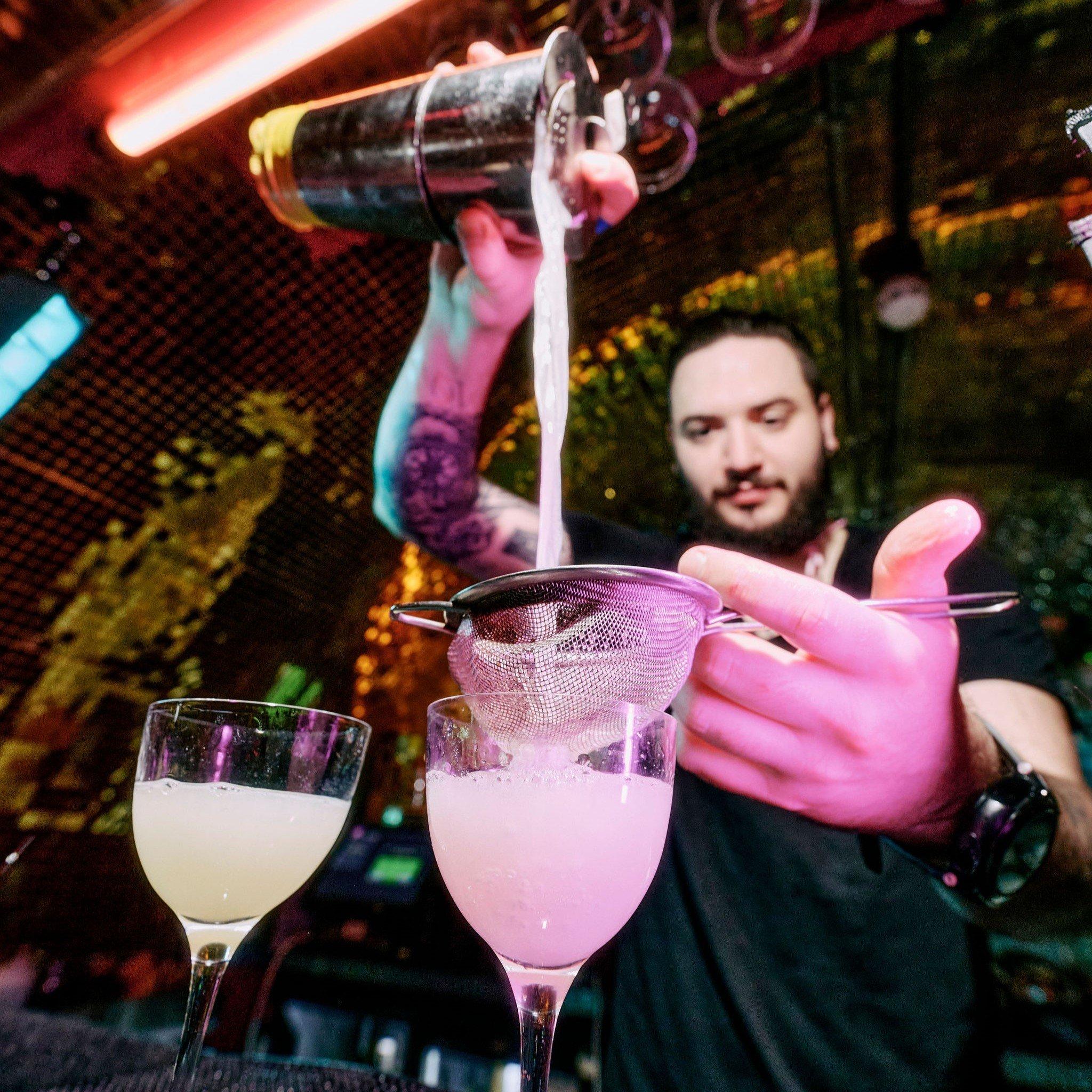 A bartender pouring cocktails in Blame Gloria