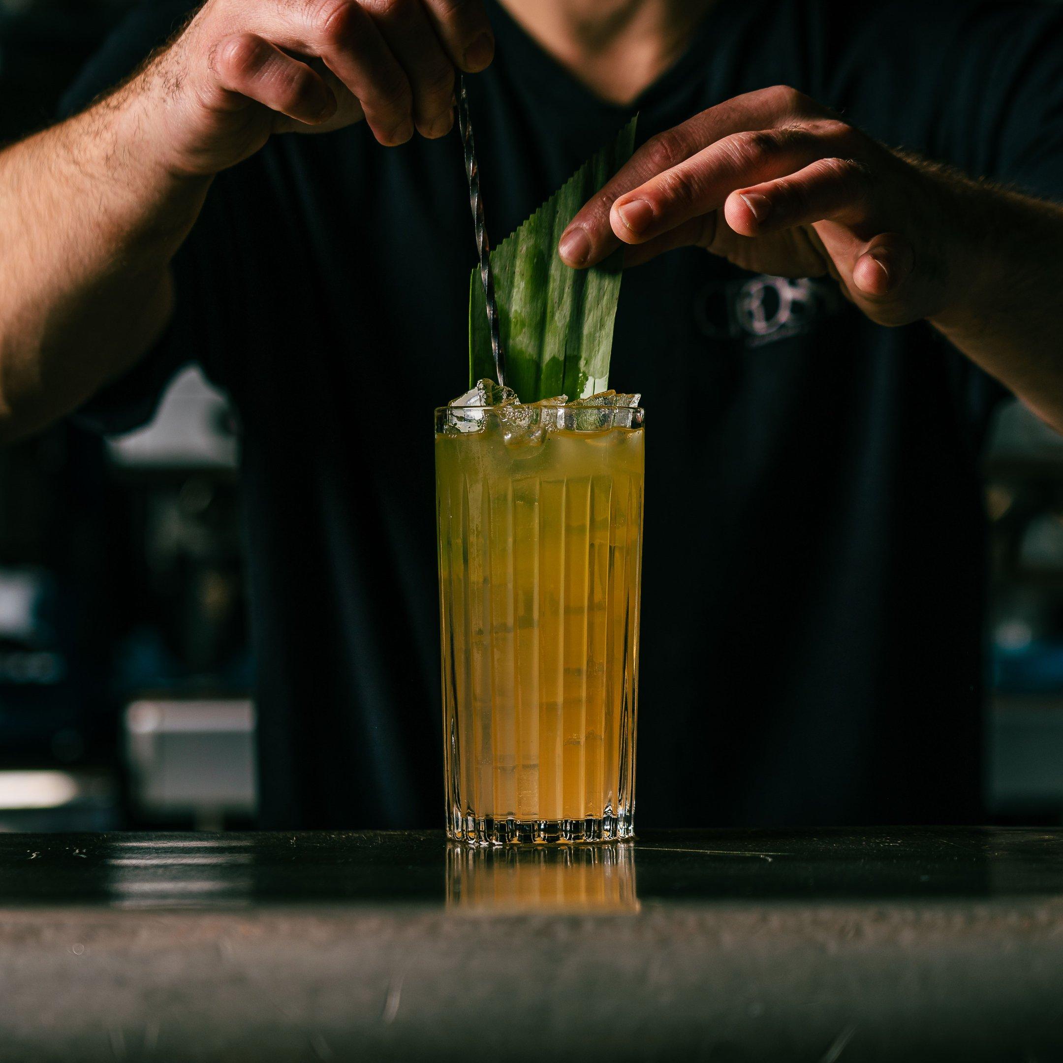 A bartender stirring a heavenly colada mocktail at Tuttons