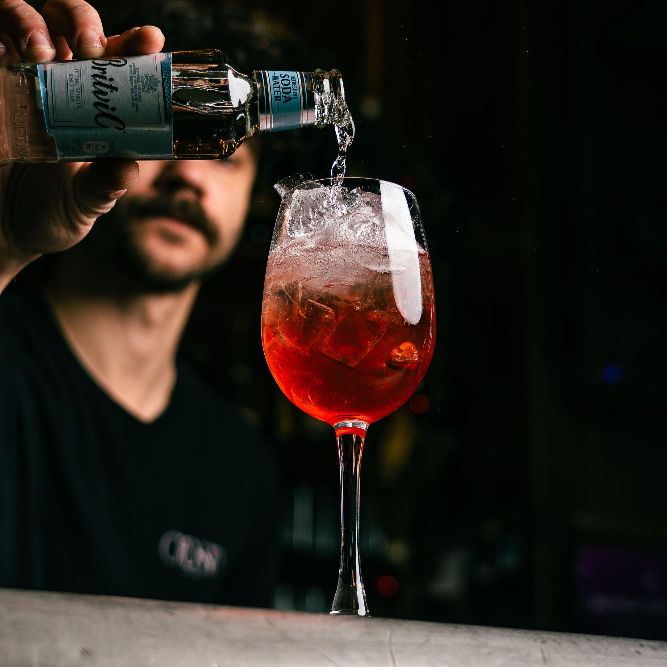 A bartender pouring a Wilfred's Spritz mocktail at Tuttons