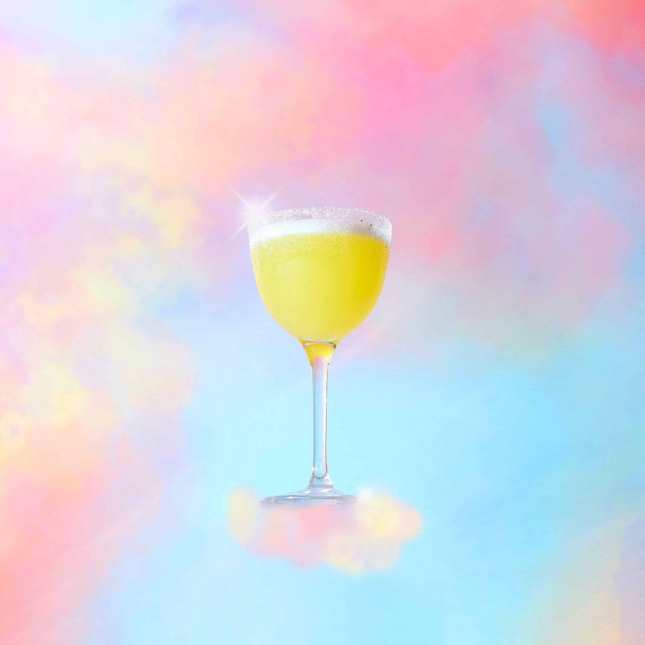 A FIIT Margs Tonight Josephine mocktail in front of a cloud background