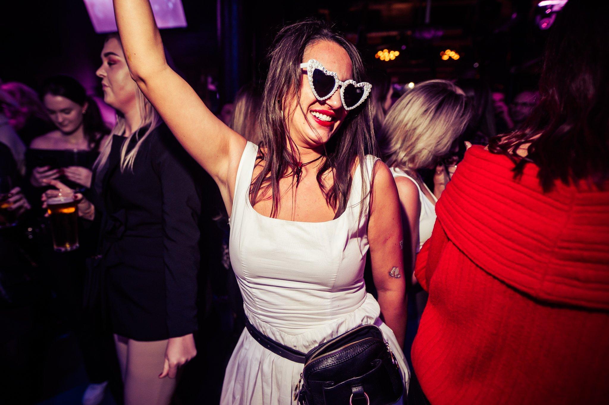 Guest wearing heart shaped glasses and dancing in Piano Works