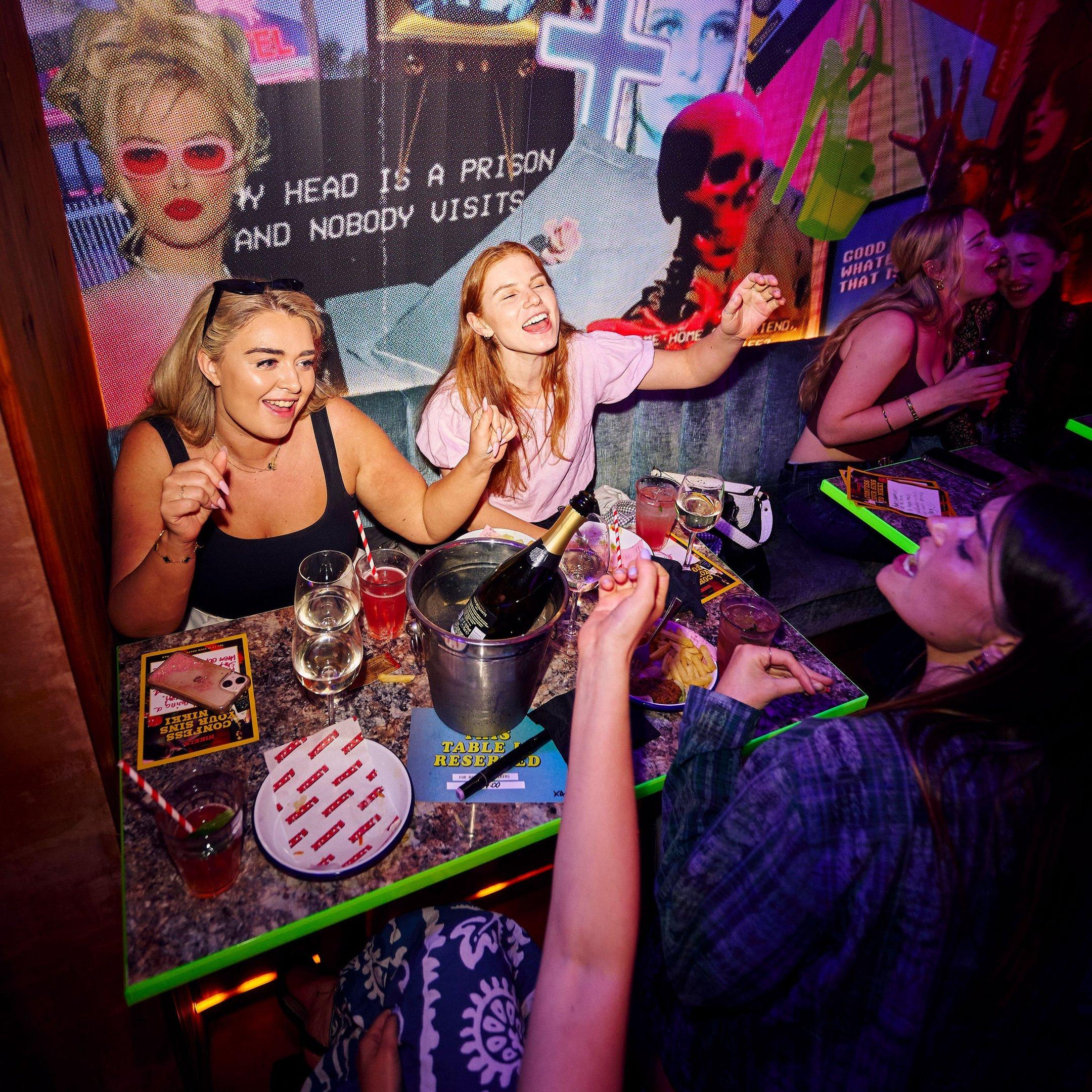 Women singing and enjoying a bottomless brunch in Nikki's bar