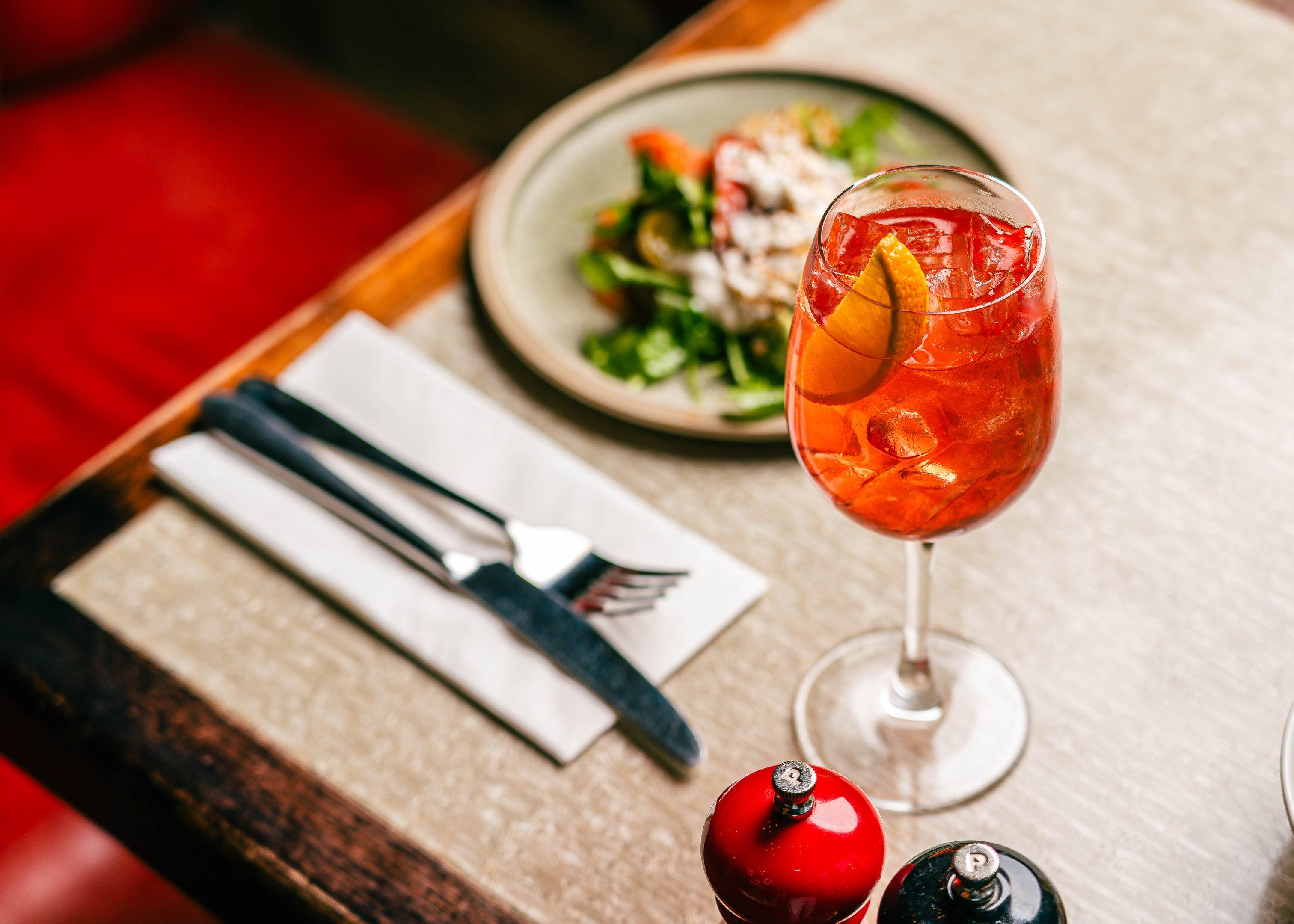 A cocktail and dinner dish on a table in Tuttons