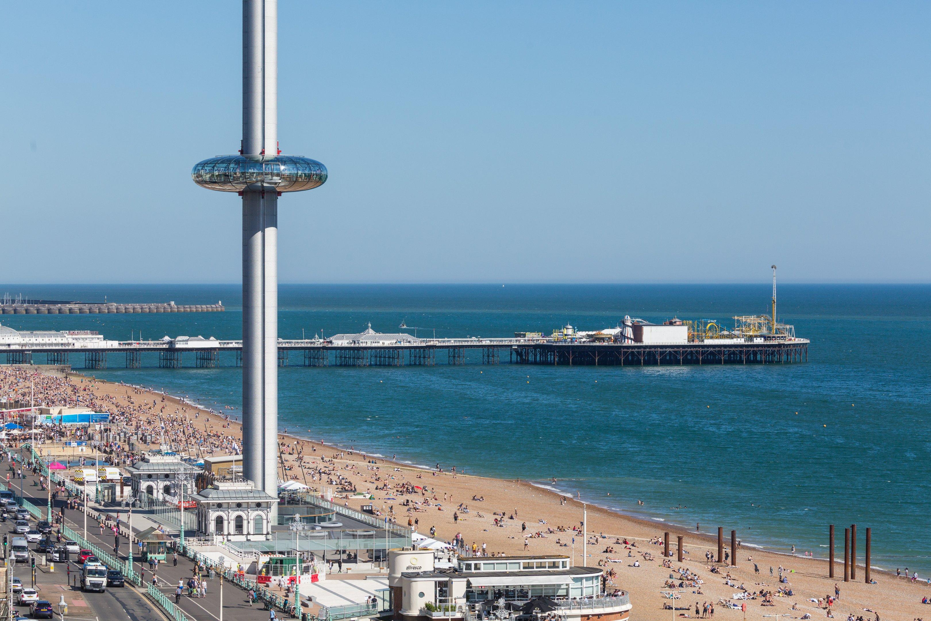 A wide beach shot of the Brighton i360 Tower