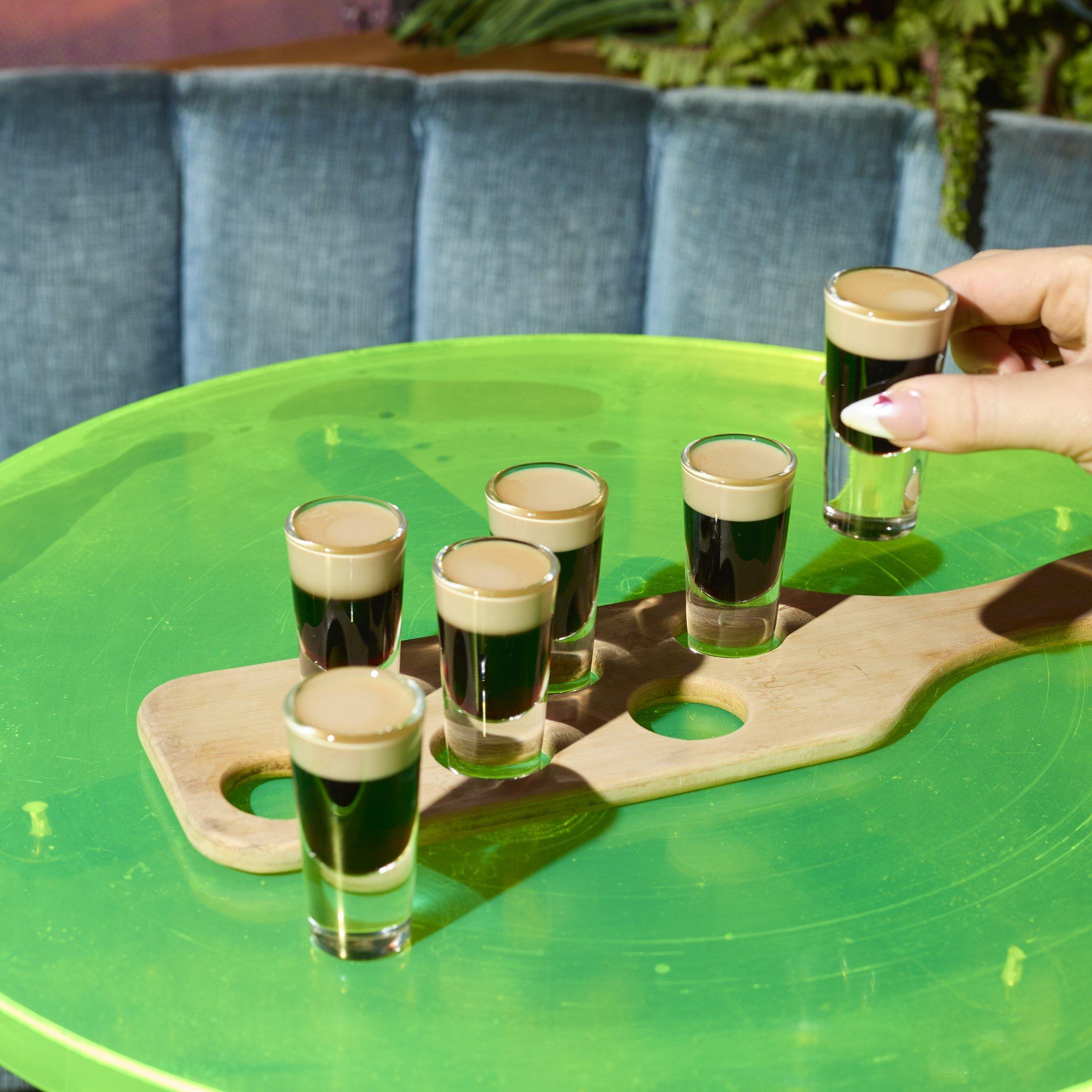 A shot paddle with 6 shots of Baby Guinness on a table in Nikki's