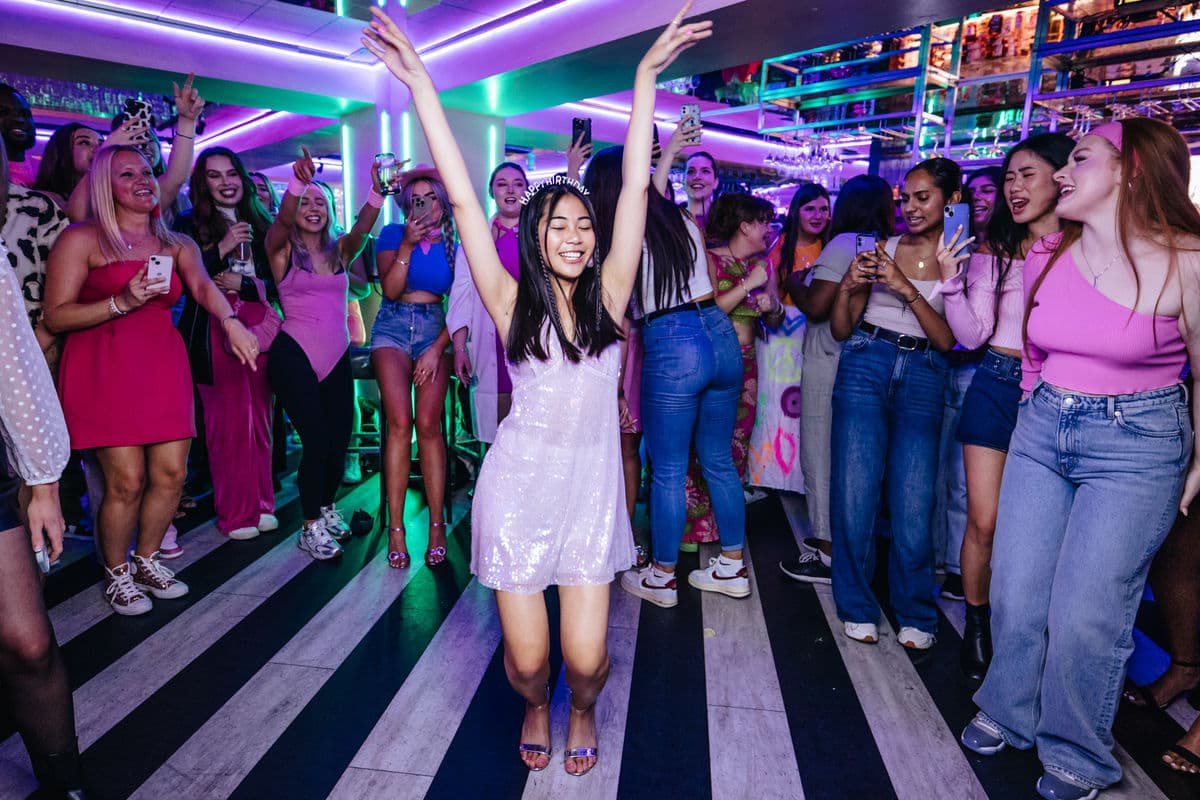 A girl dancing surrounded by other guests in Tonight Josephine