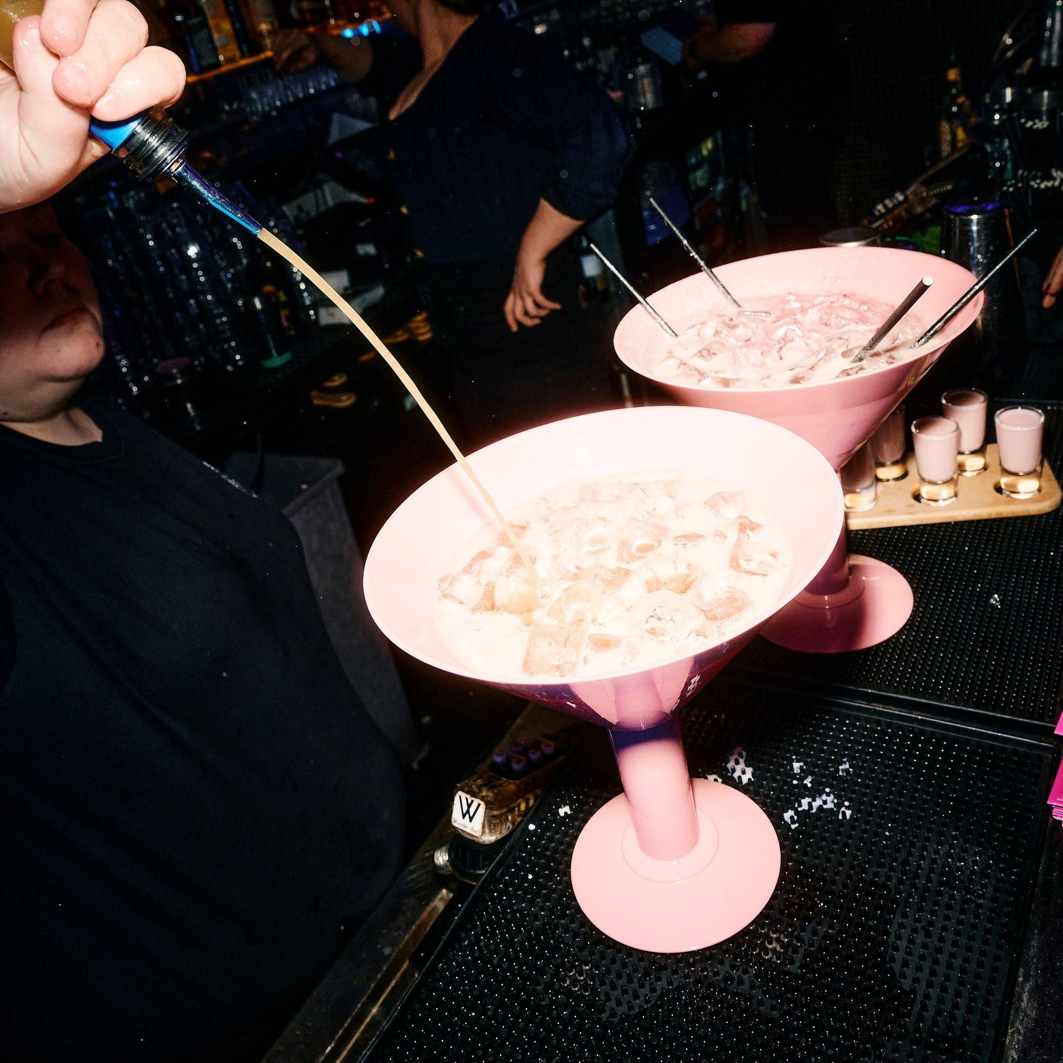 A bartender pouring two Megatini cocktail sharers in Tonight Josephine