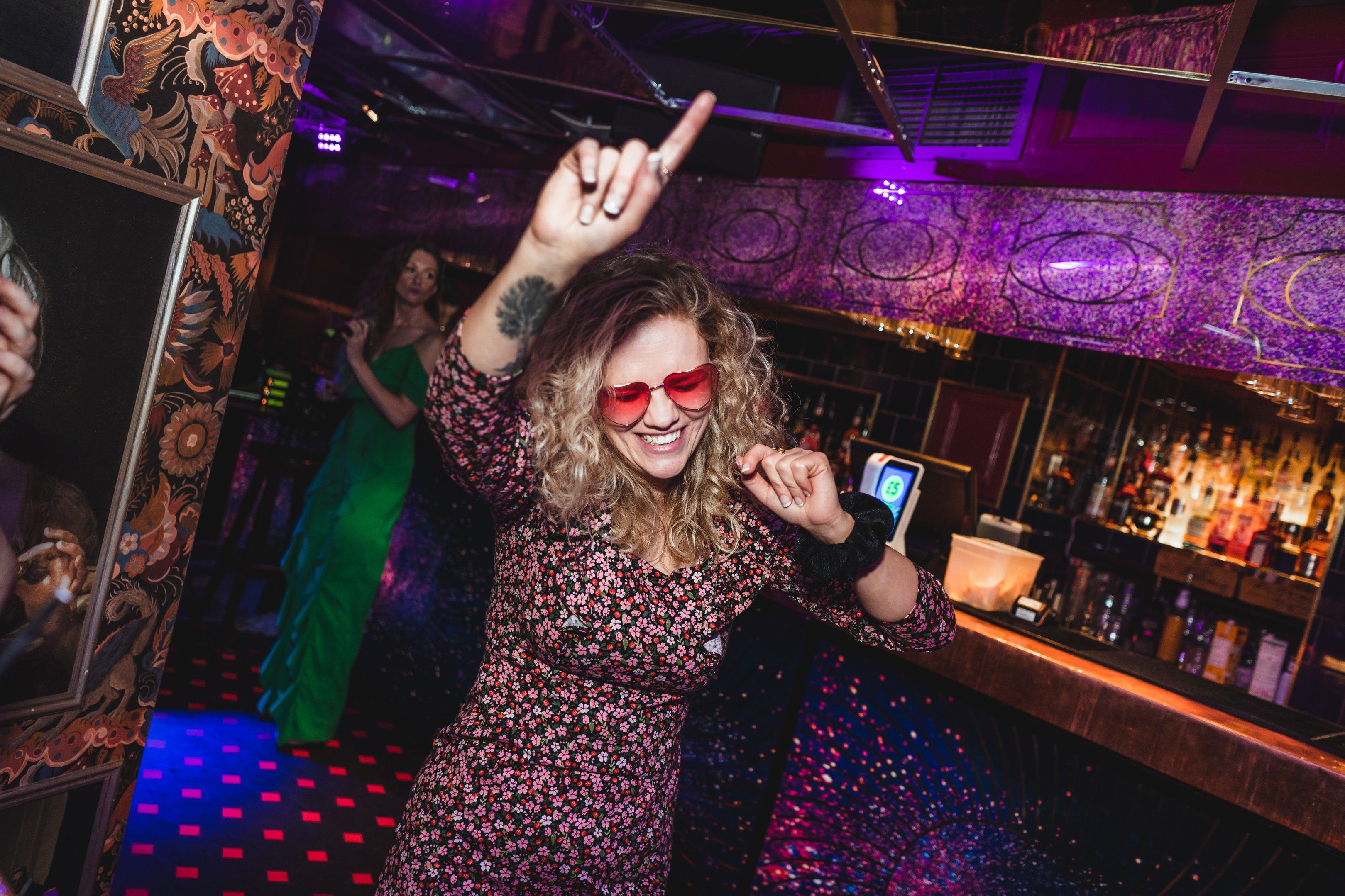 Woman dancing and smiling in The Escapologist