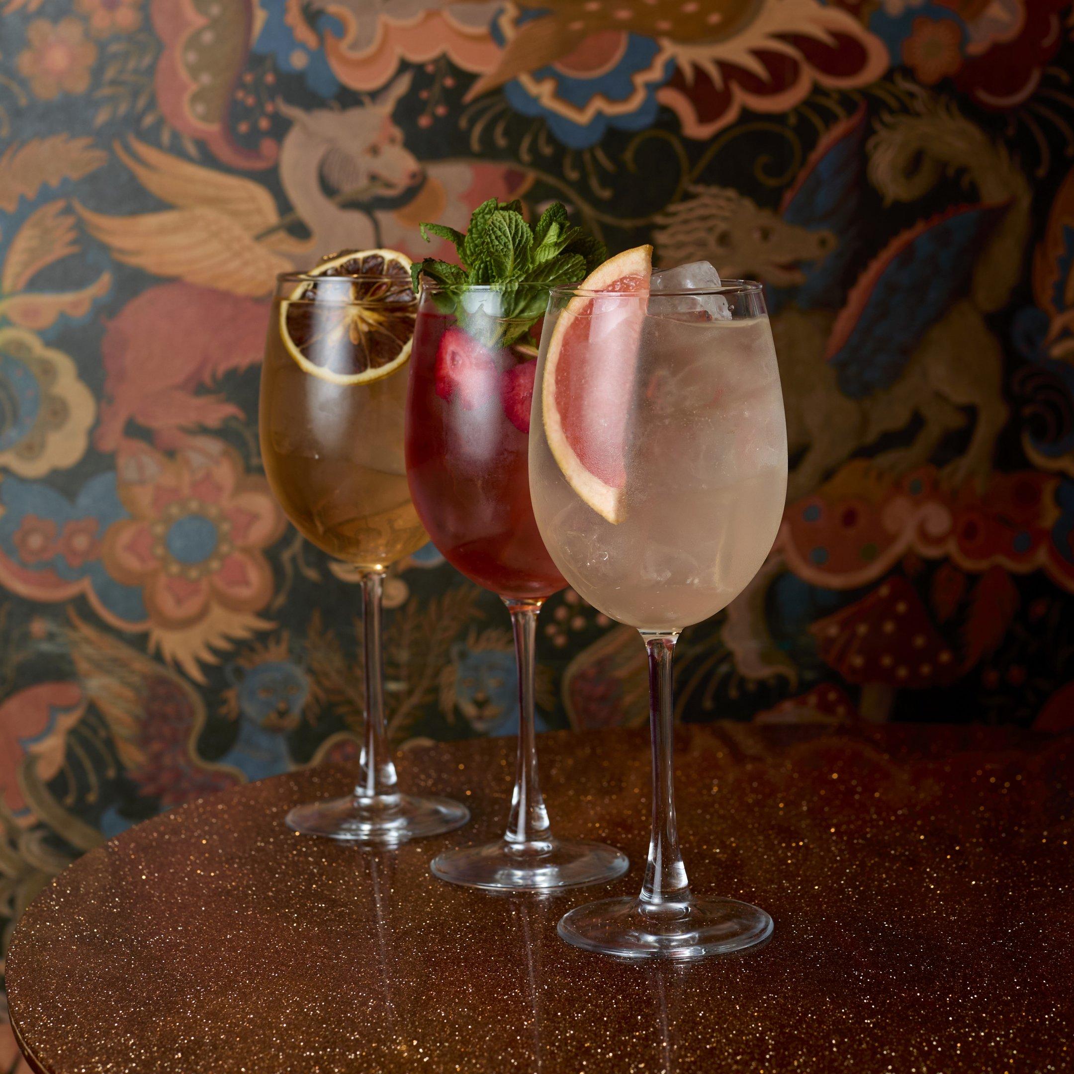 Three spring cocktails on a table in the Escapologist