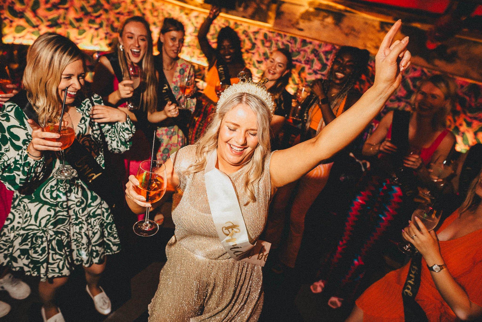 A bride-to-be drinking and dancing in Blame Gloria