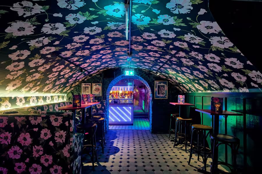 A private hire room in Blame Gloria Bristol with green rose patterns on the walls and furniture