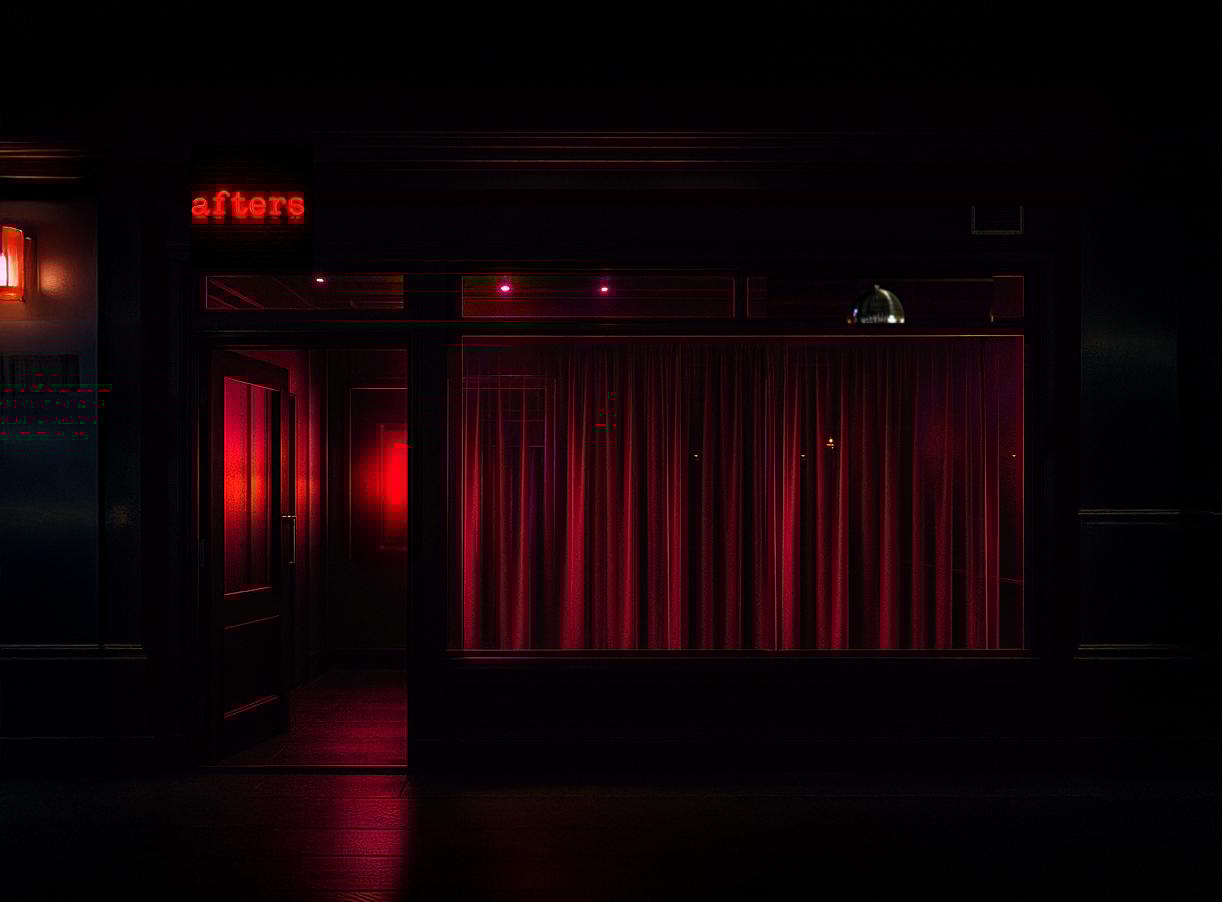 An image showing a dark bar with a red neon sign above the door reading 'afters'
