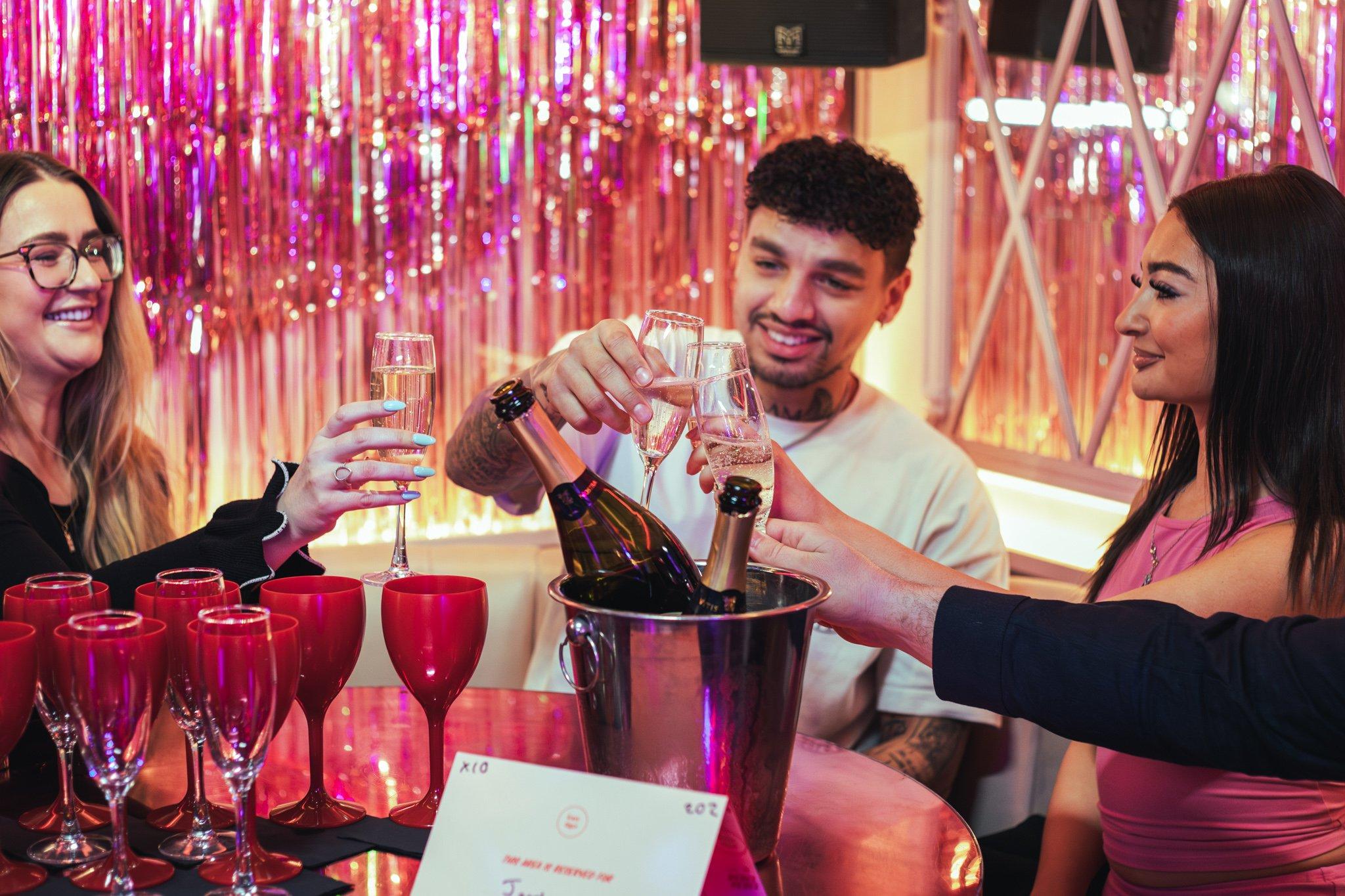 Guests clinking their prosecco glasses at a table ready for a bottomless brunch in Tonight Josephine