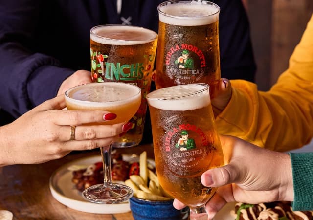 4 people cheersing drinks at Walkabout