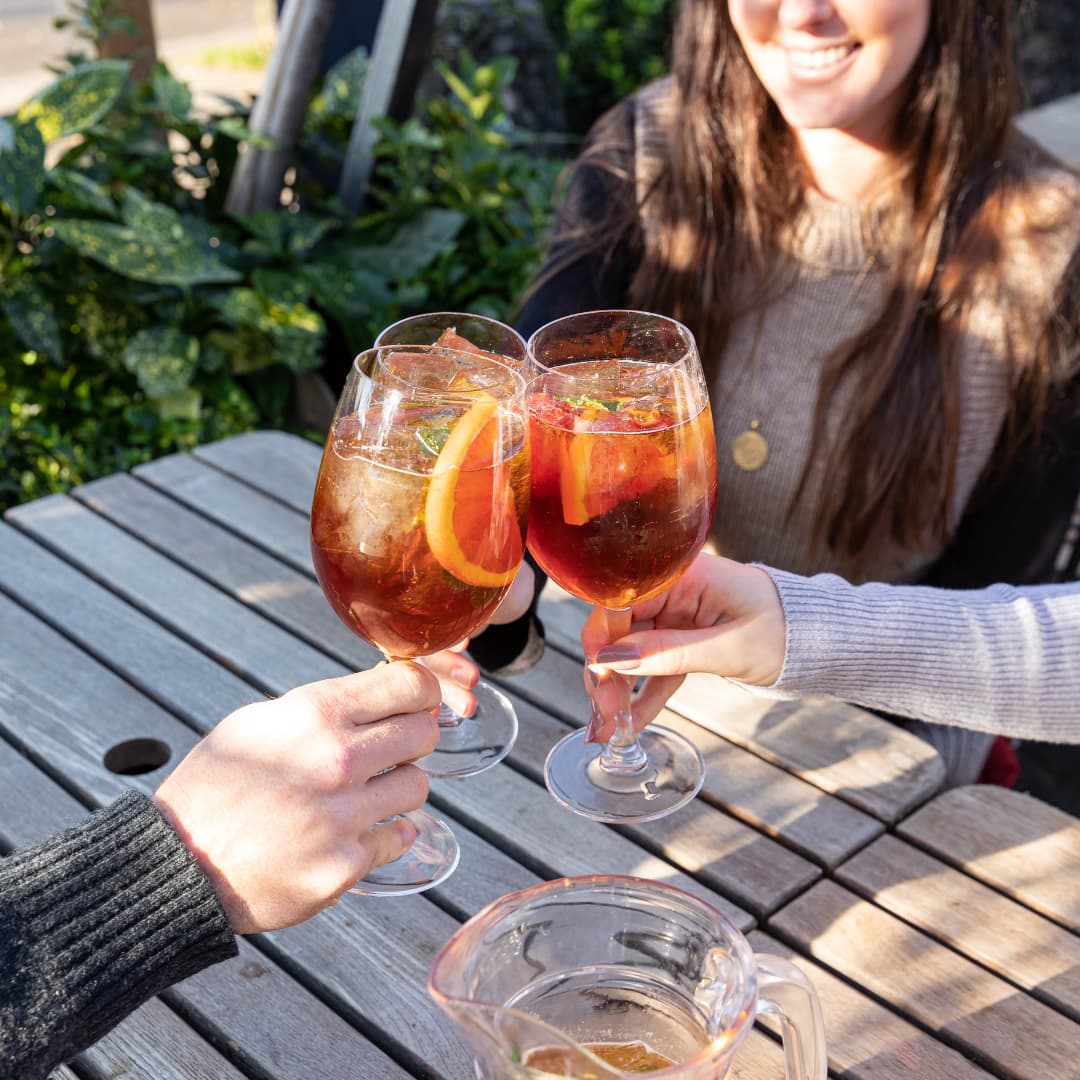 clinking glasses filled with Pimm's cocktail
