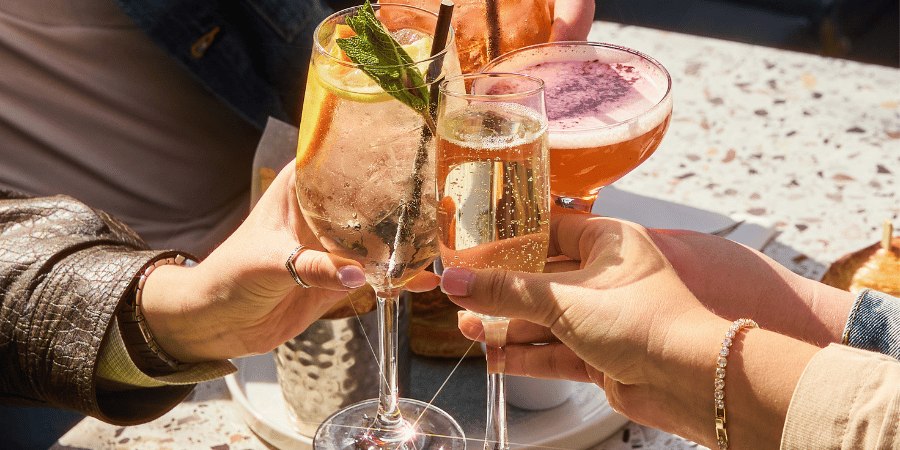 Cocktails clinking in the sun